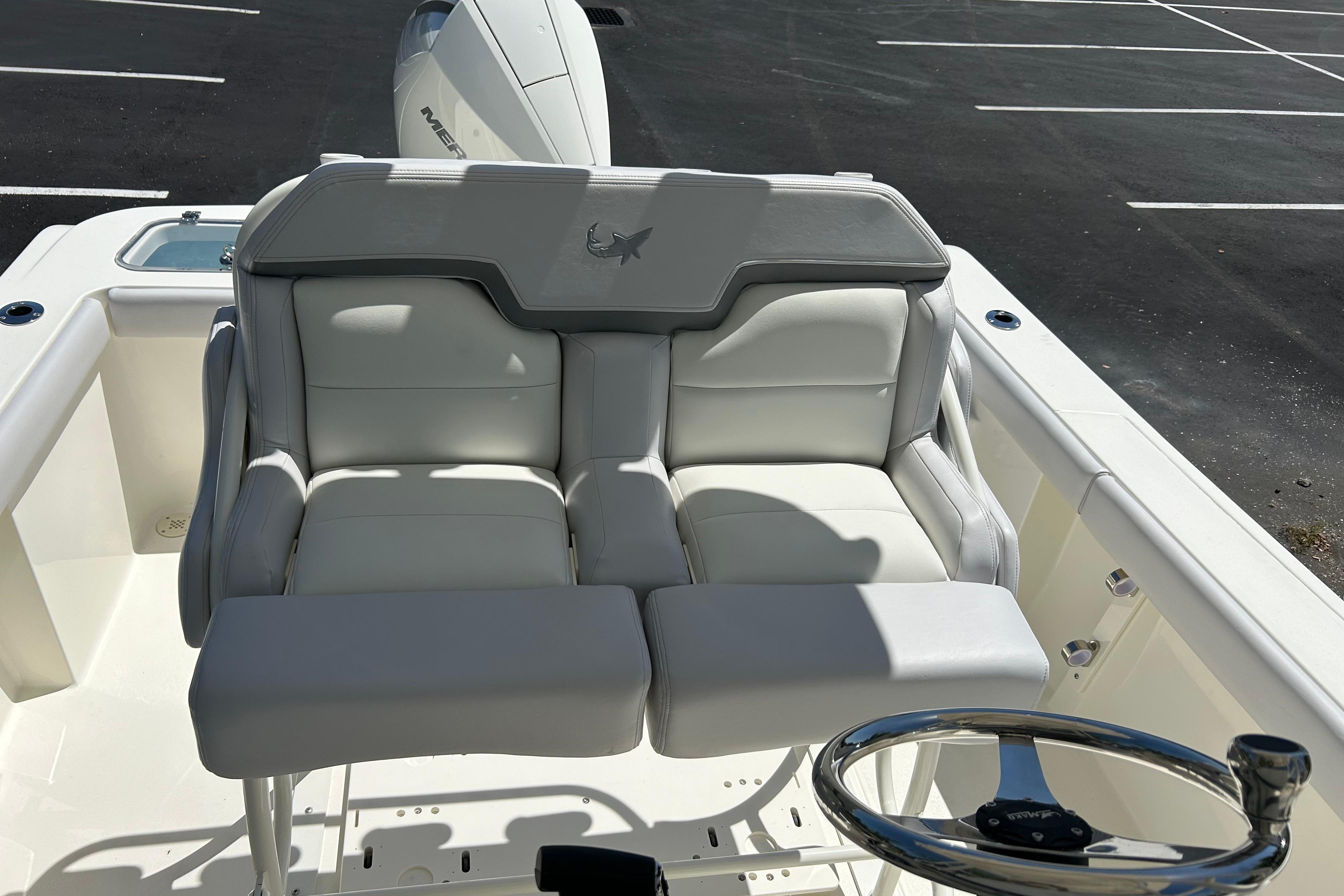 2026 Mako 226 Center Console boat with plush seating and steering wheel.