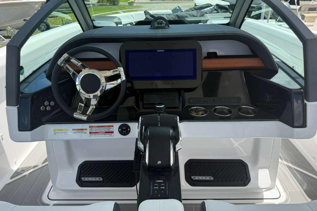 Cockpit of 2026 Monterey Elite 30 OB boat with modern steering and controls.