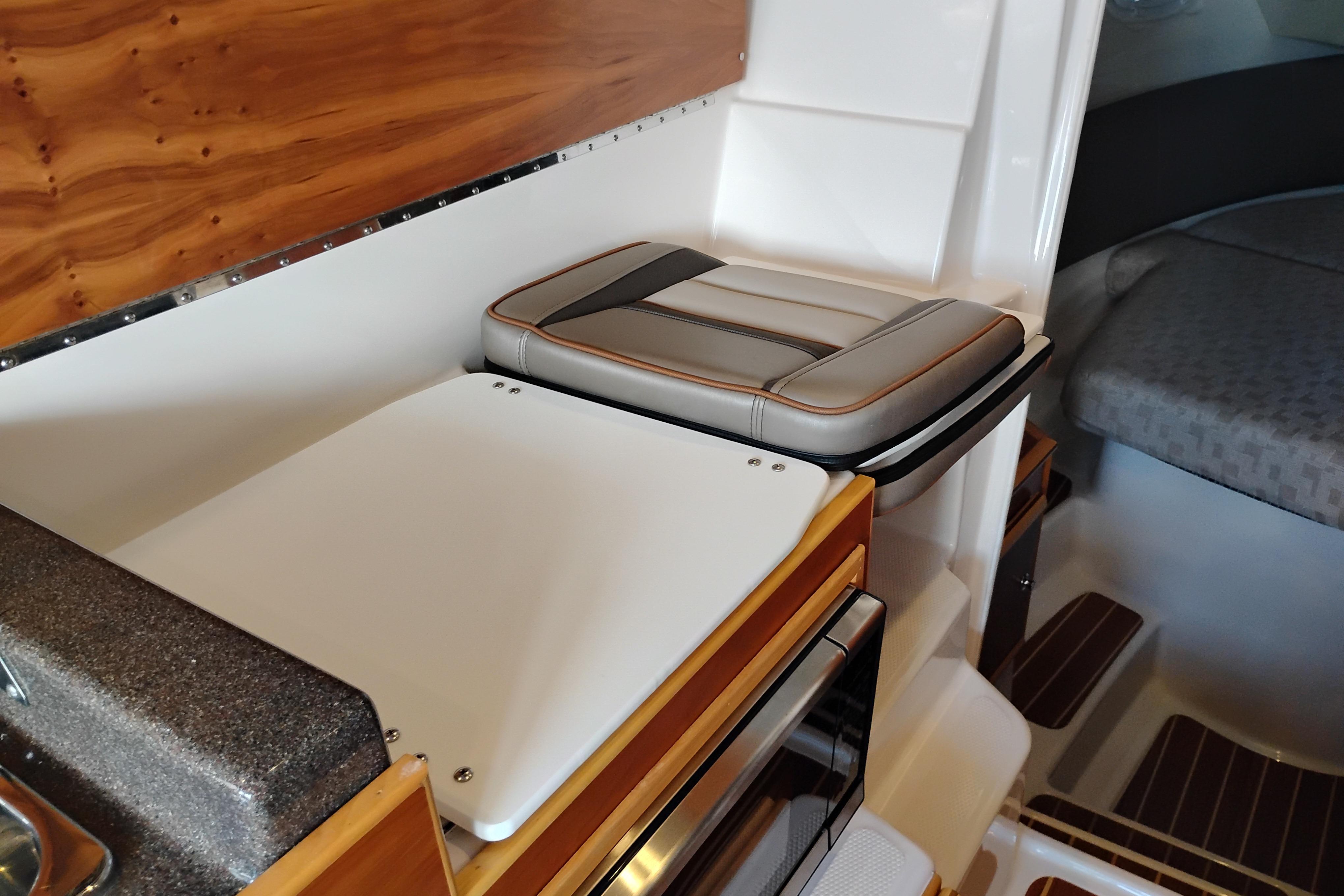 Interior of 2022 Cutwater C-32 Coupe featuring seating and wood accents.
