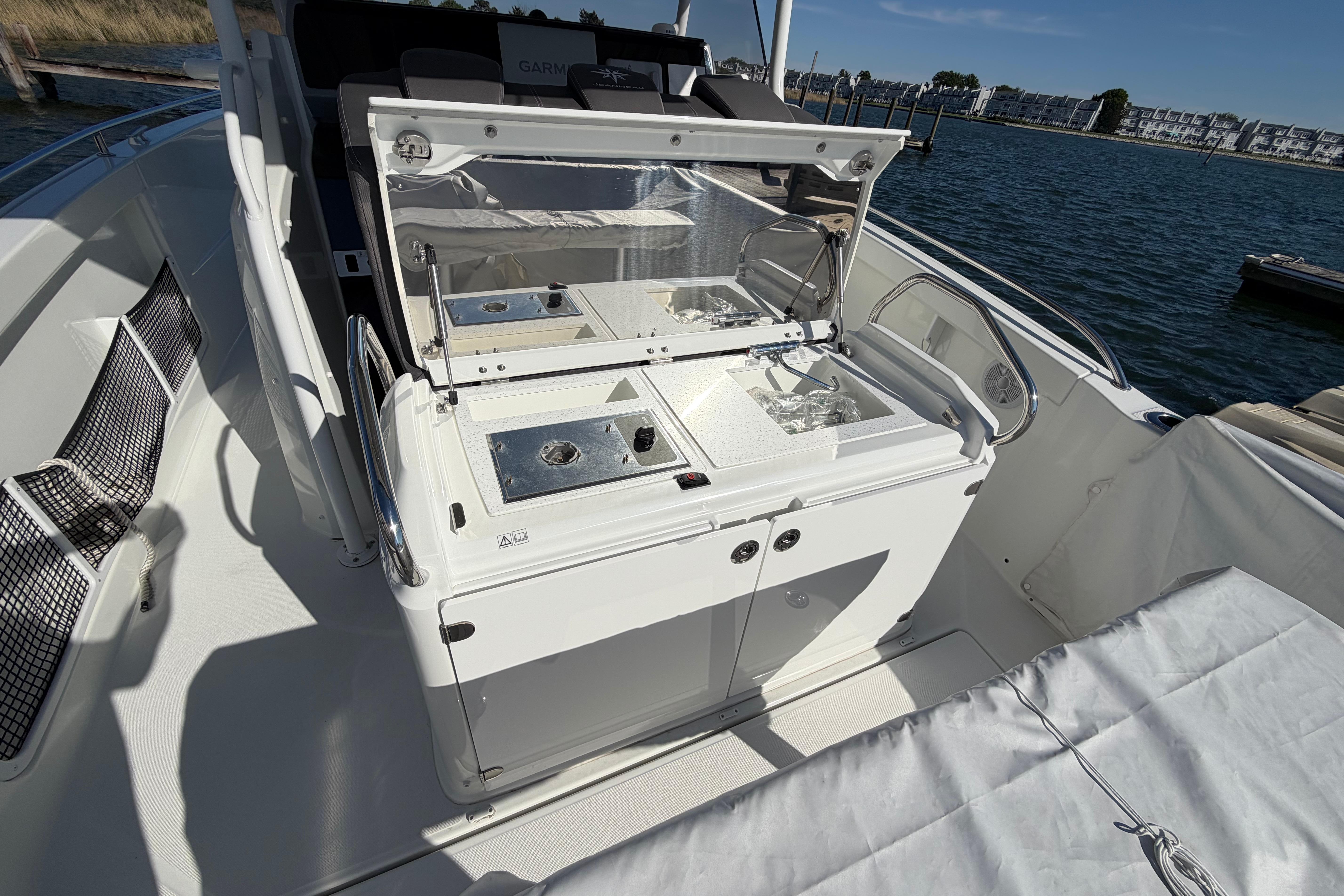 2024 Jeanneau Leader 9.0 CC boat interior with open storage compartments and sleek design.