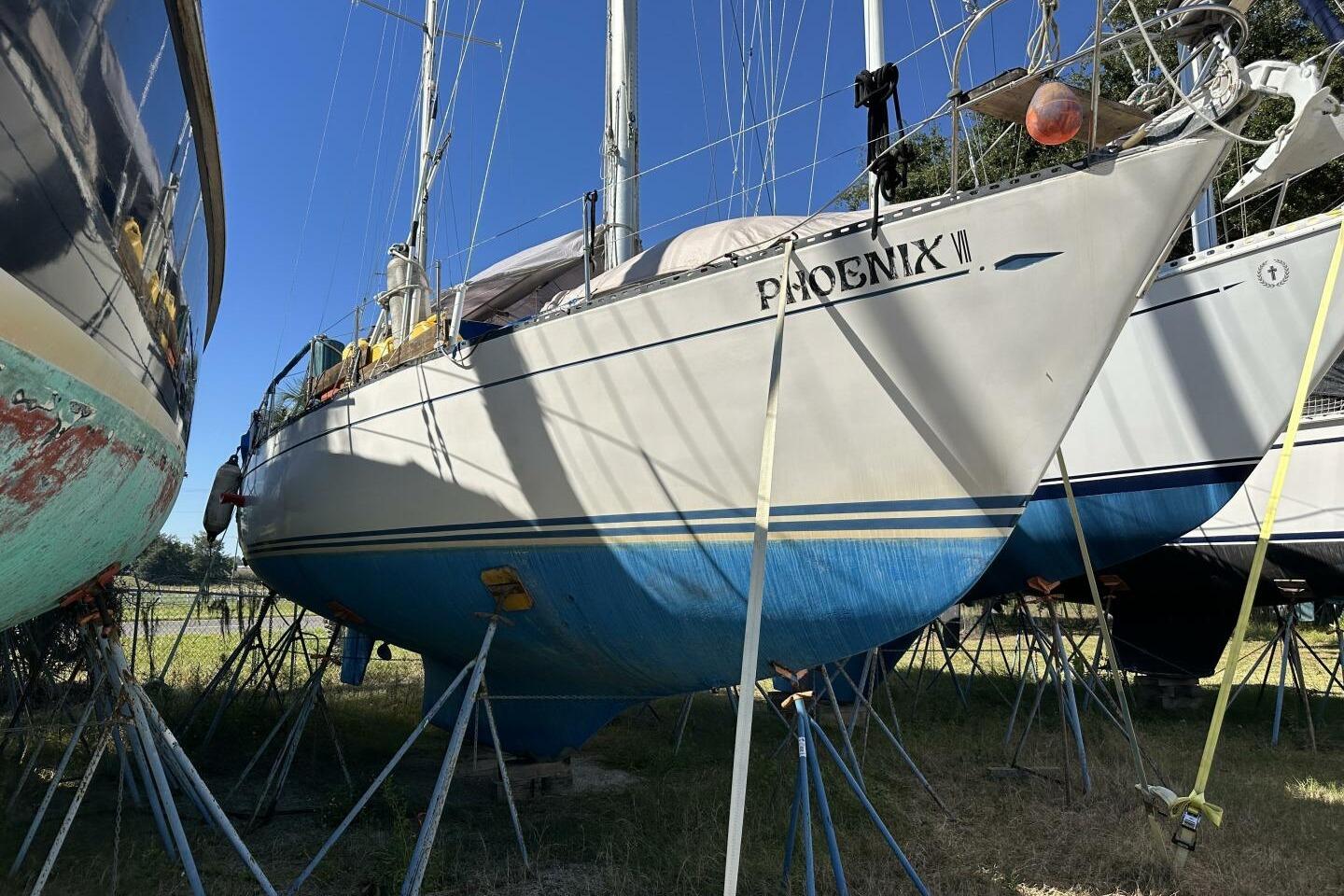 Sailboat "Phoenix VII" on stands, Hughes 3910 model, 1979, with blue hull.