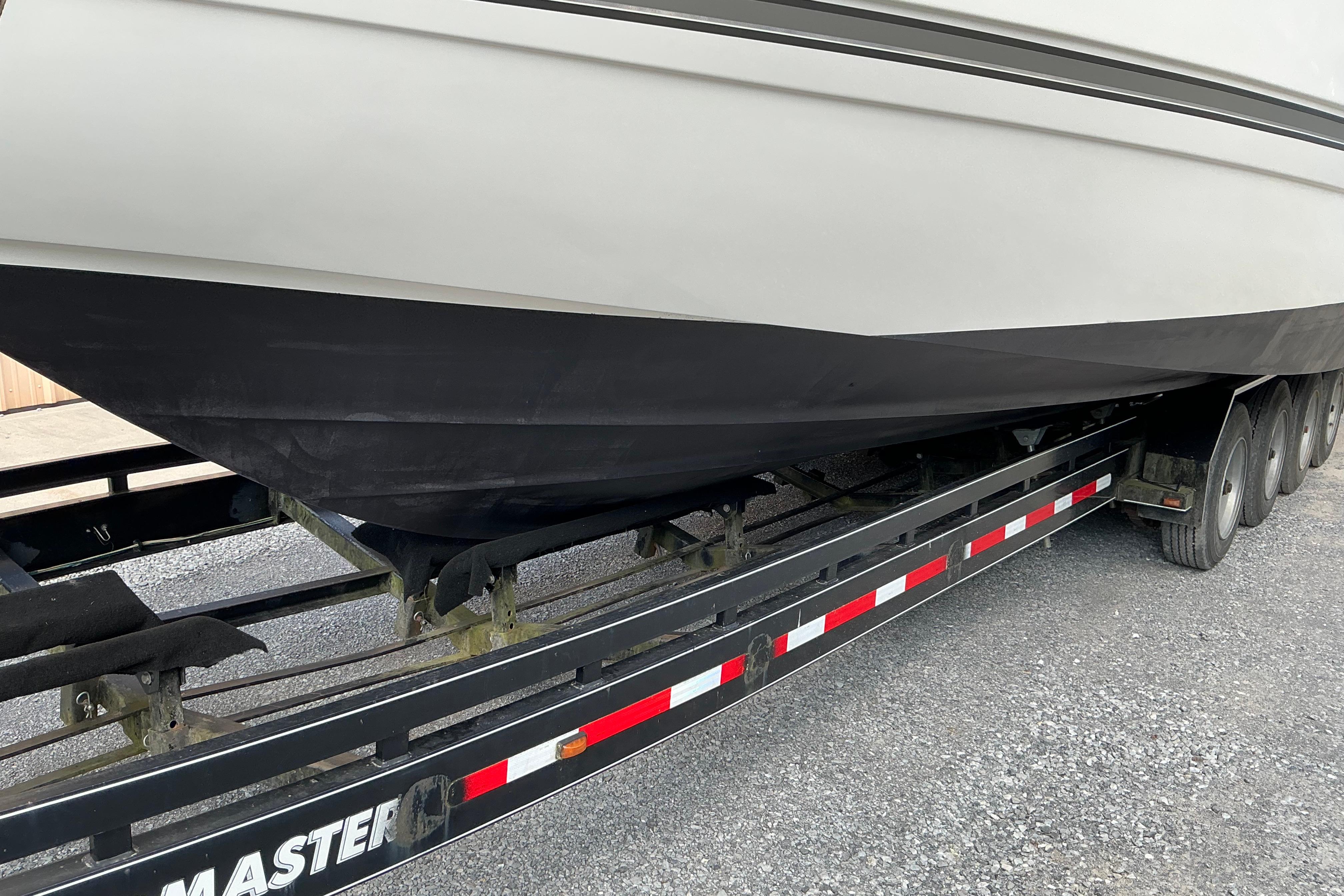 2005 Cruisers Yachts 370 Express on trailer, side view of hull and wheels.