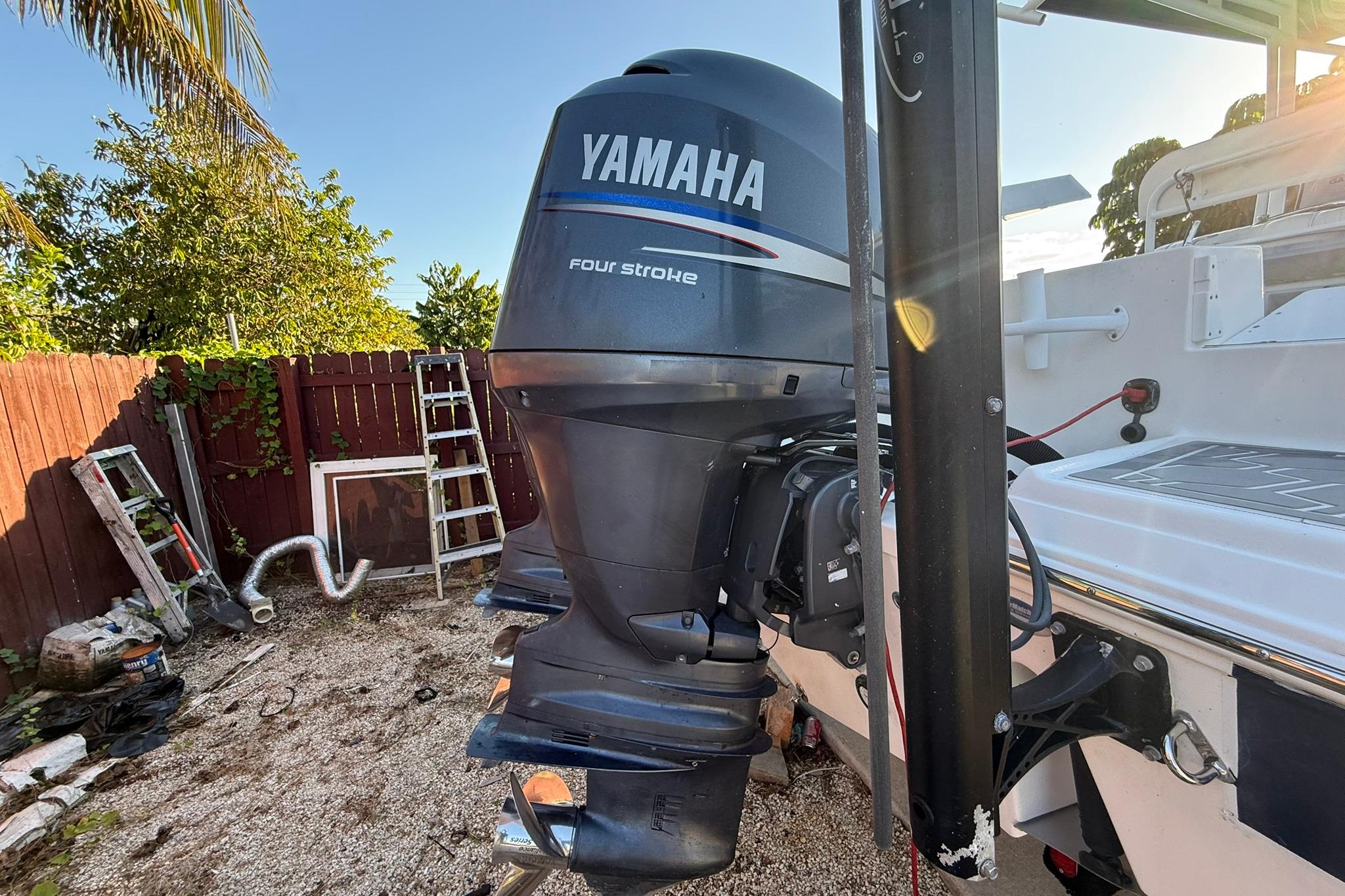 2014 Sea Fox 256 Commander with Yamaha four-stroke outboard motor in a backyard setting.