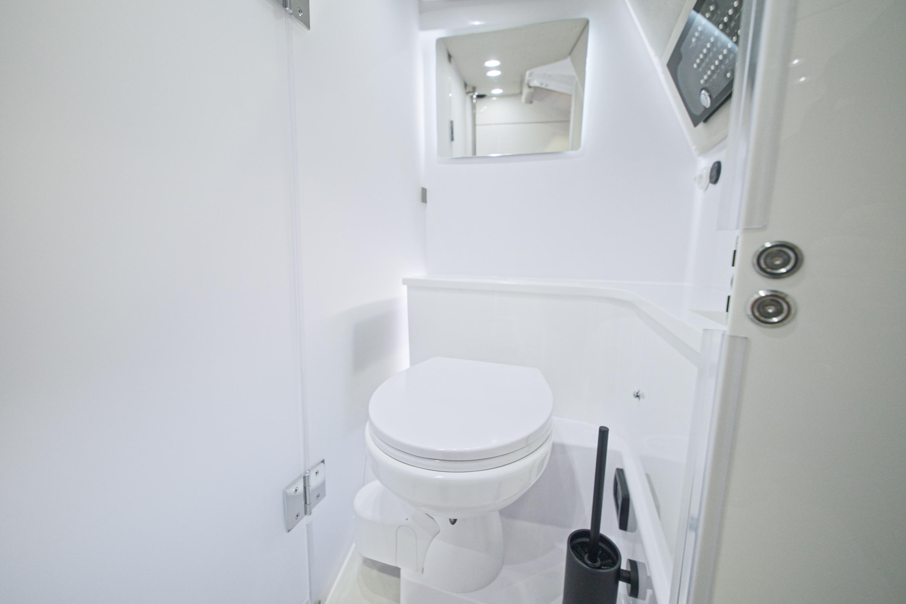 Modern bathroom interior of 2026 Axopar 37 XC Cross Cabin boat.