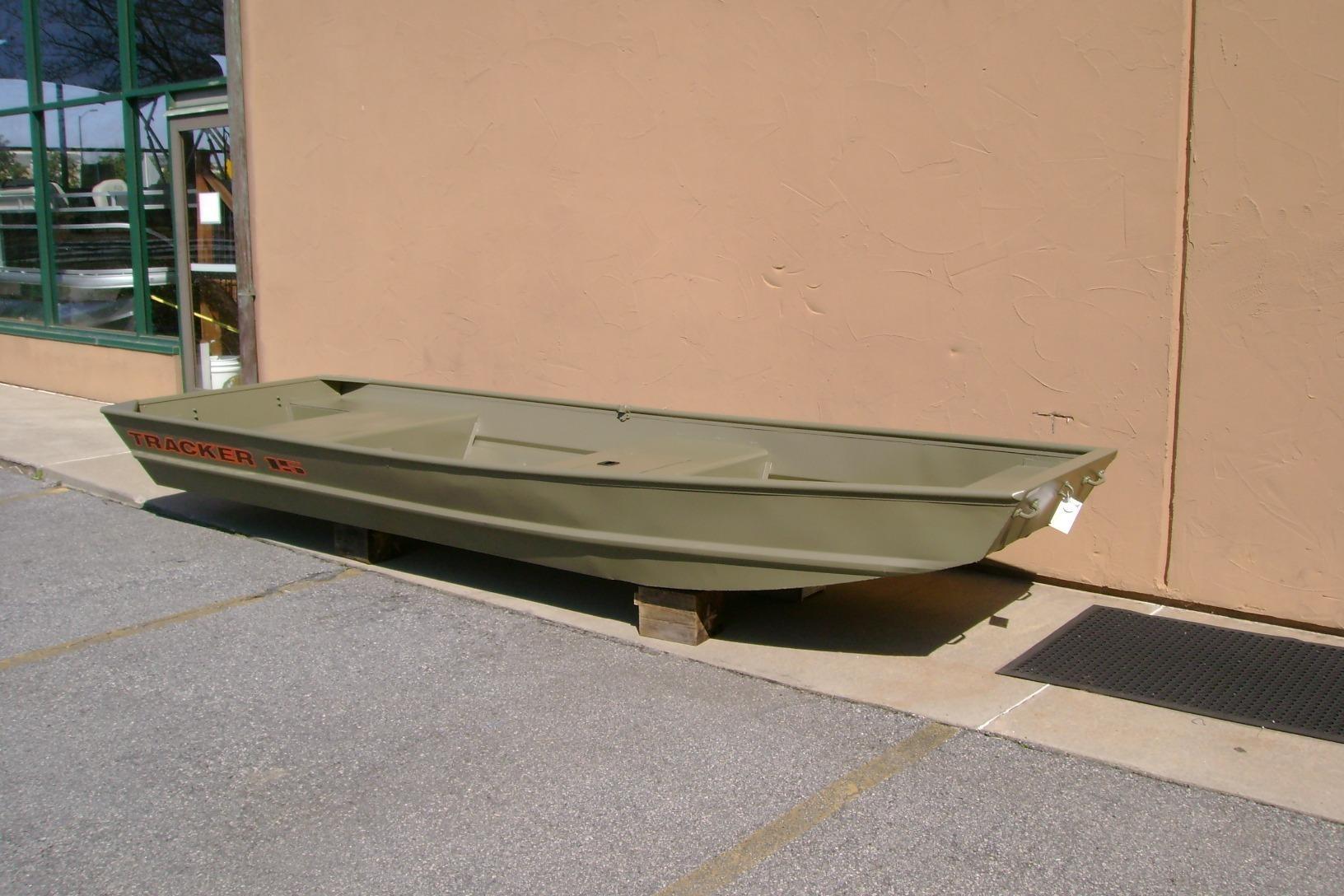 2026 Tracker Grizzly 15 Jon boat displayed outdoors on wooden blocks.