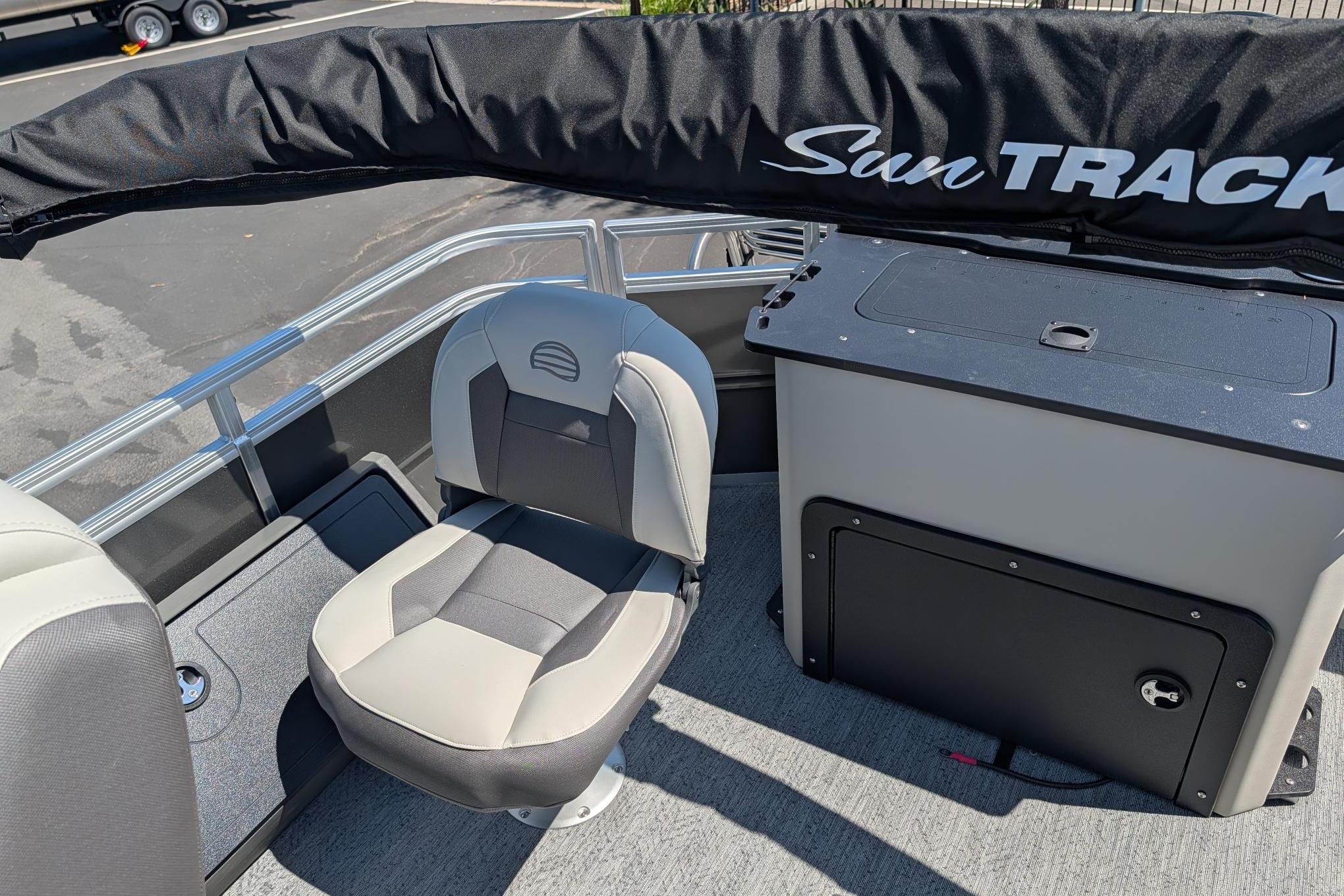 2026 Sun Tracker Fishin' Barge 22 DLX interior with seating and storage.