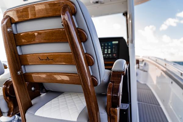 Manufacturer Provided Image: Luxury seating on 2025 Everglades 455 Center Console boat, featuring elegant wood and leather design.