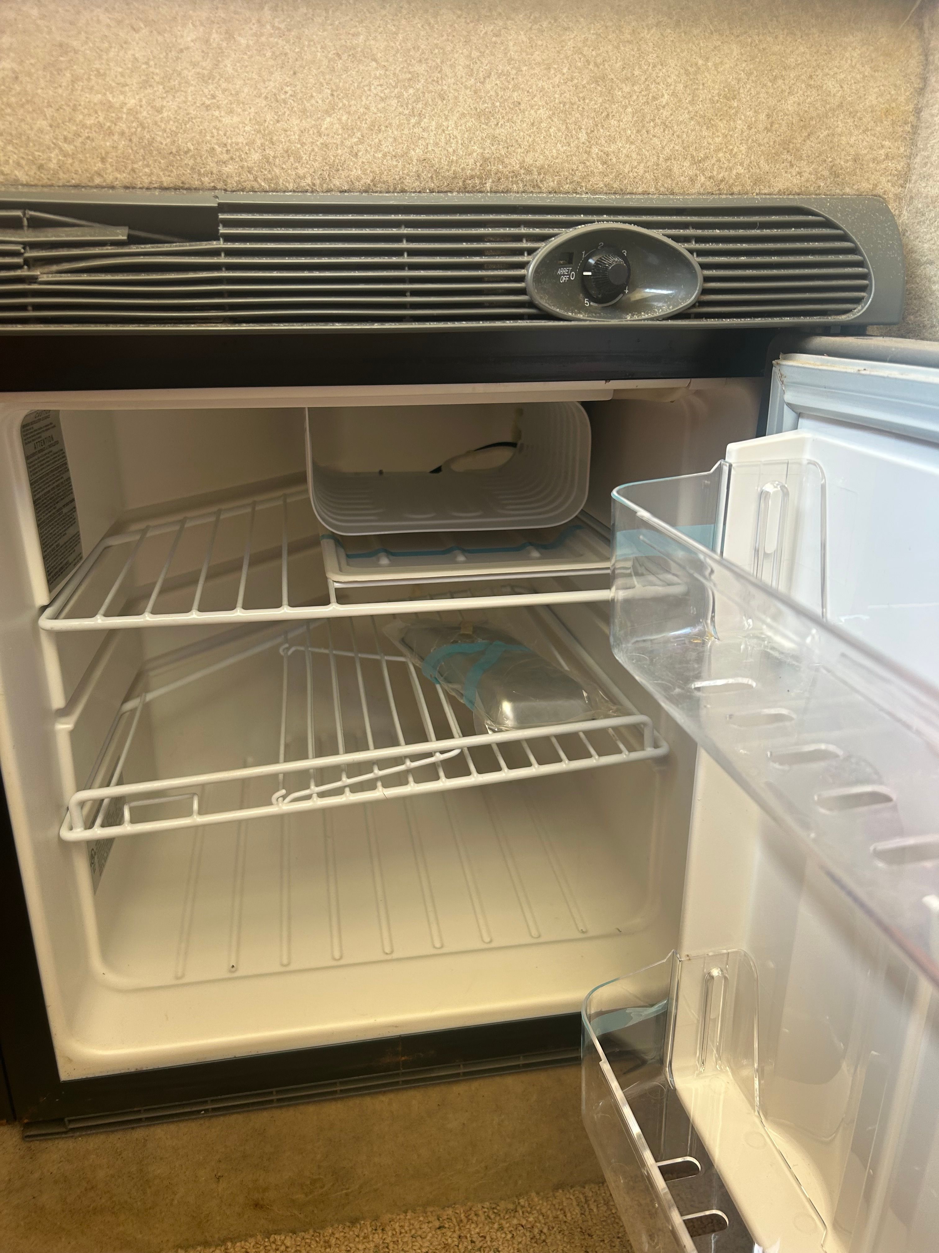 Open refrigerator in a 2005 Bayliner Classic 242 boat.