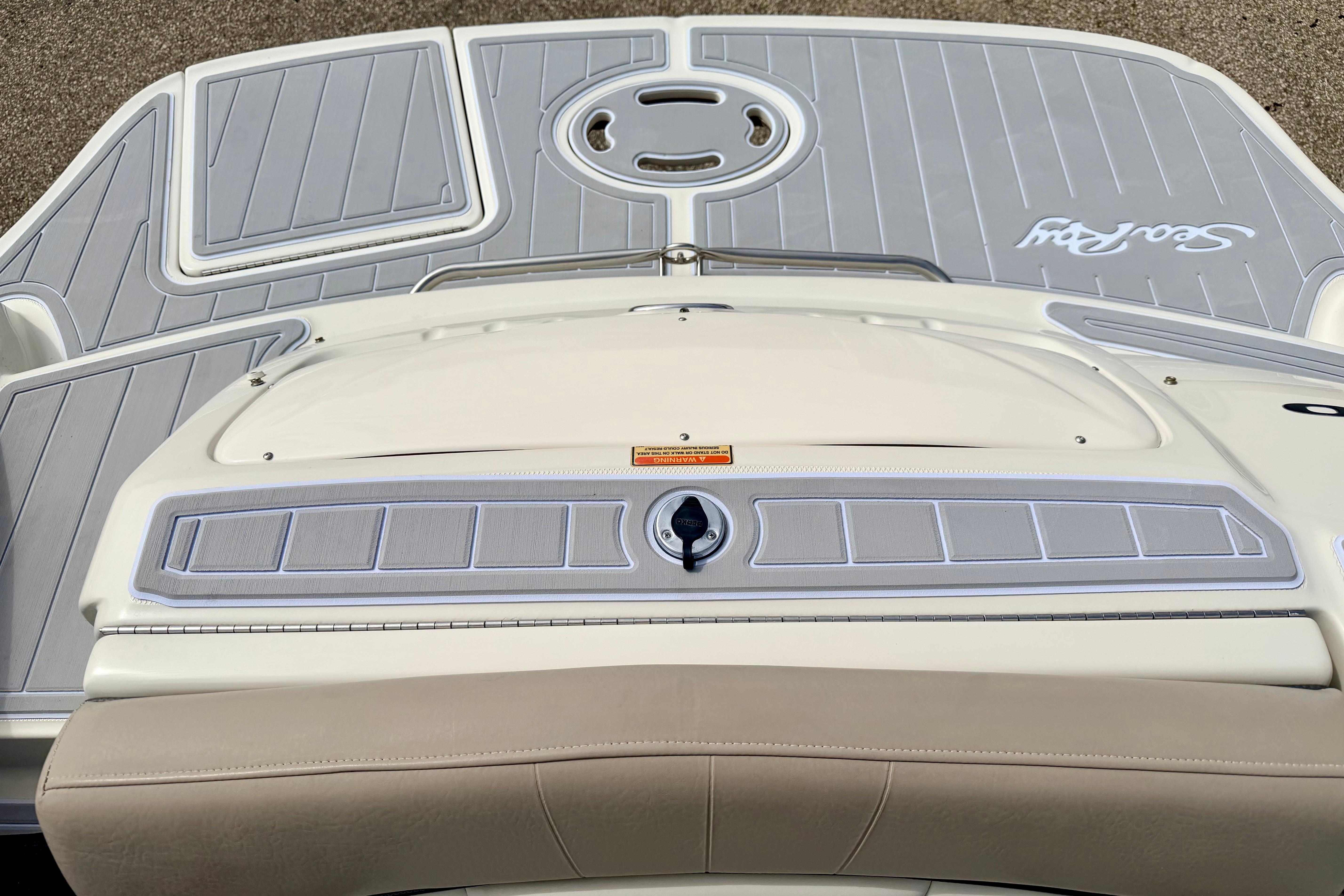 2003 Sea Ray 200 Sundeck boat deck with gray and white detailing.