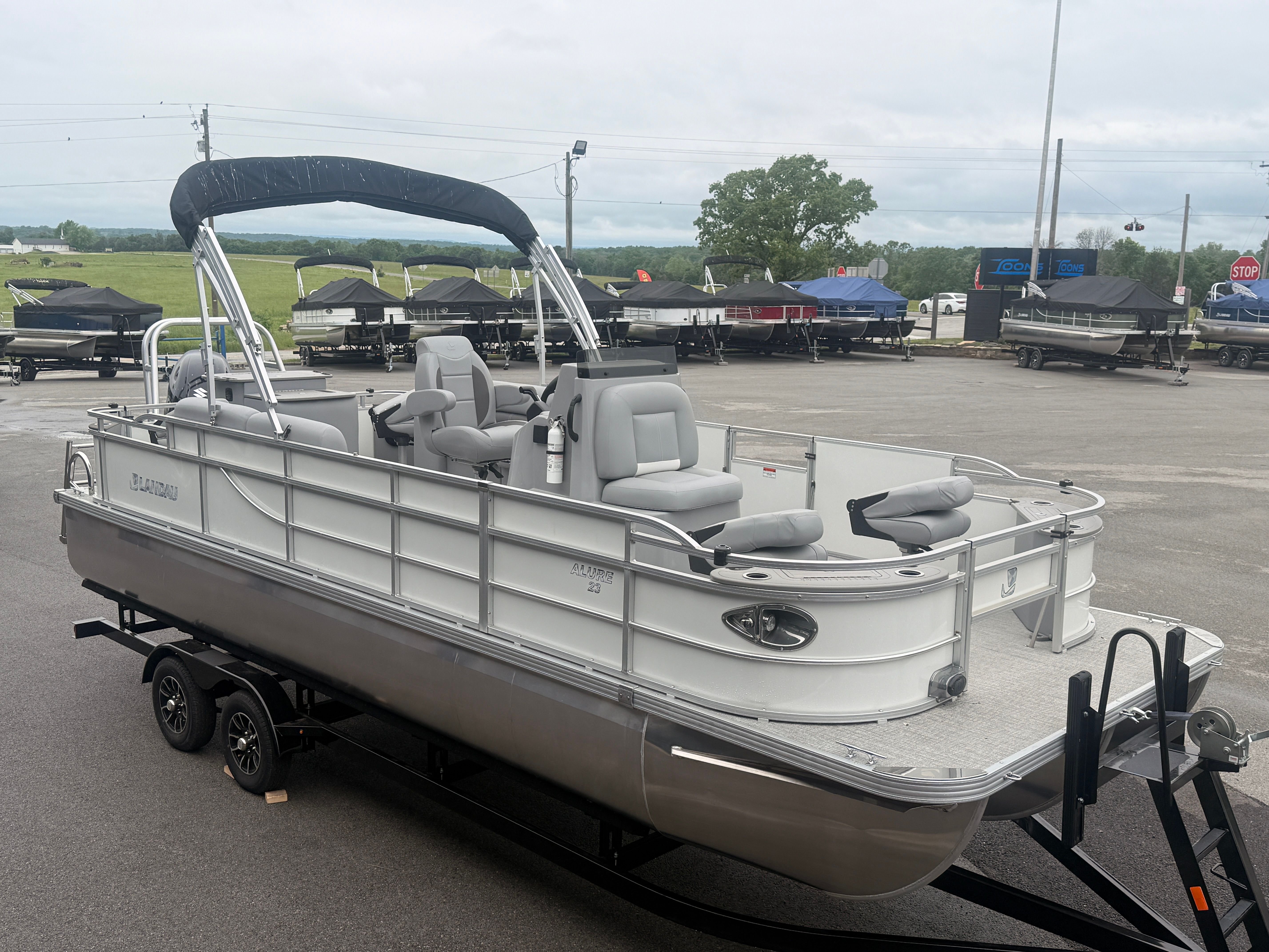 2026 Landau Alure 23CC Fish boat on trailer outdoors.