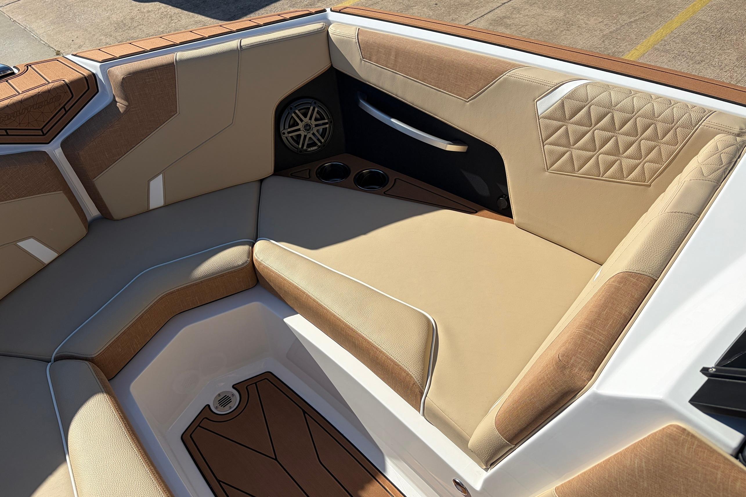 2026 Nautique Super Air Nautique GS22 interior with tan upholstery and speaker detail.