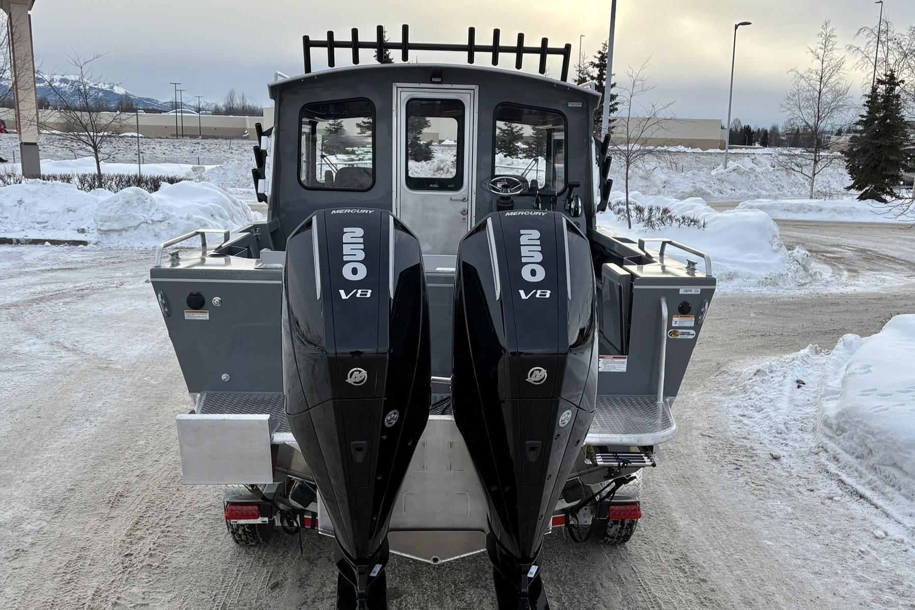 2024 Spartan 26 Maximus Pro XL boat with dual Mercury 250 V8 engines in snowy setting.