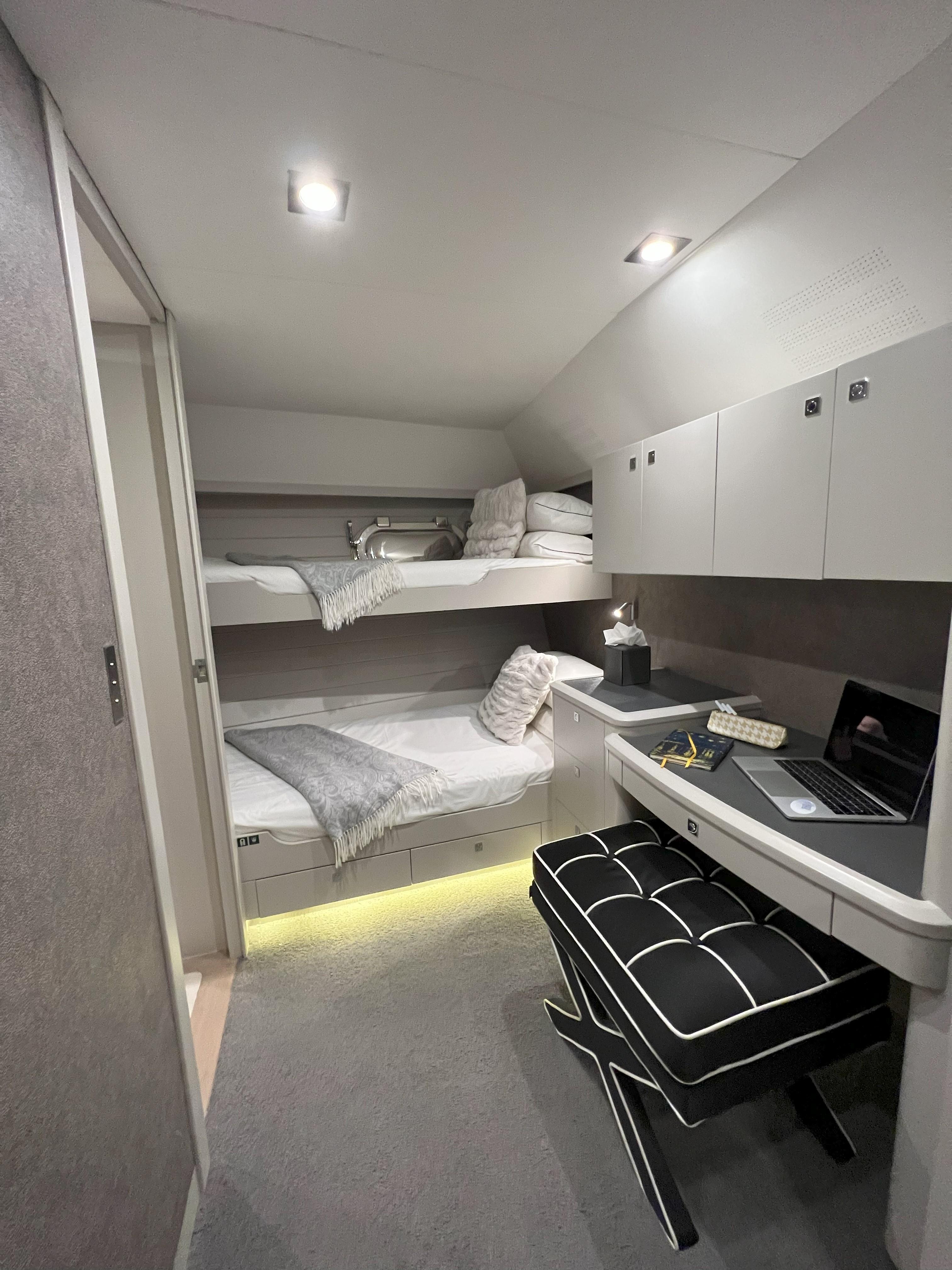 Luxurious cabin interior of 1994 Alloy Yachts Alloy 35, featuring bunk beds and a workspace.