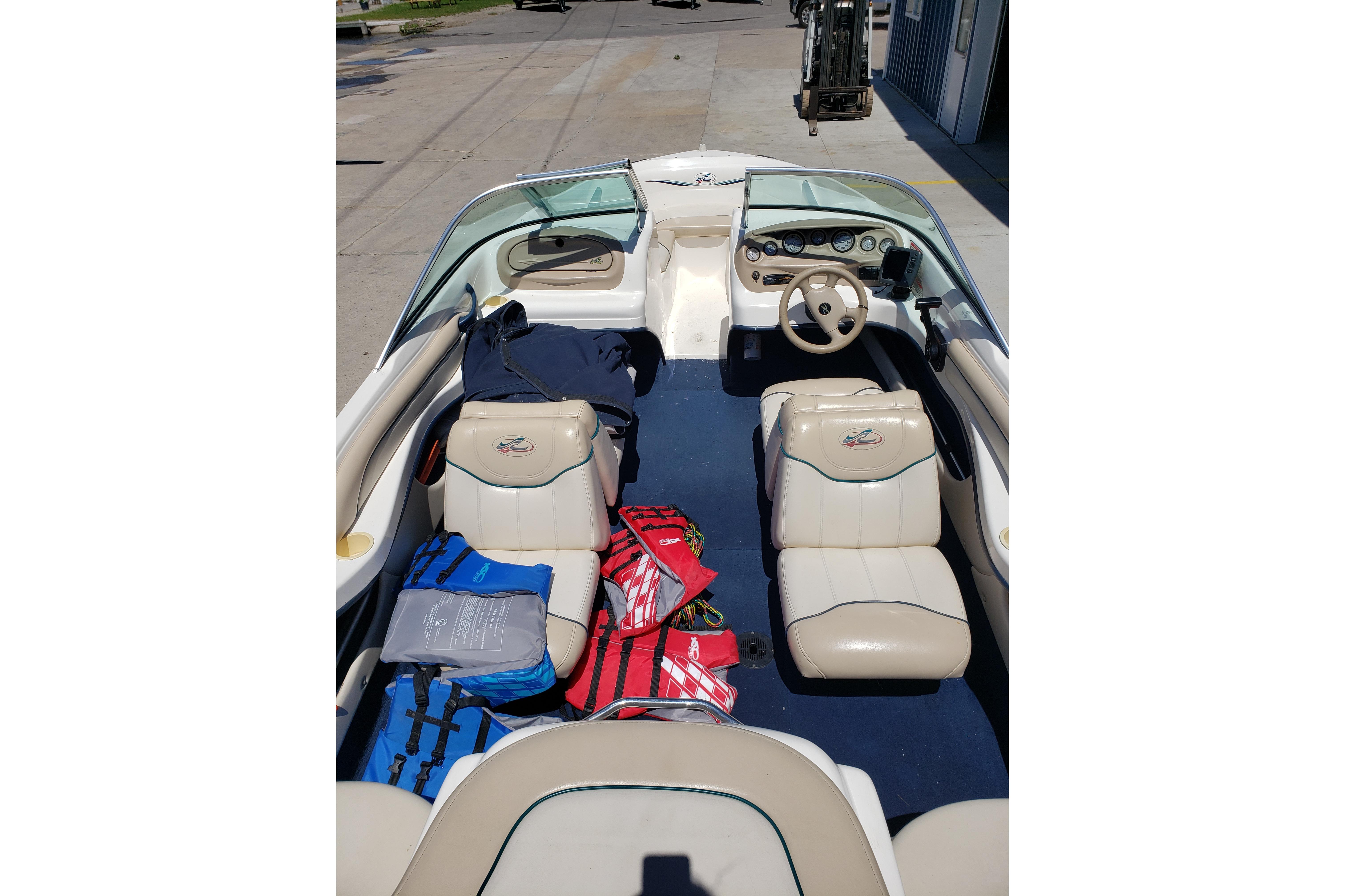 1998 Sea Ray 180 Bow Rider interior with beige seating and life jackets.
