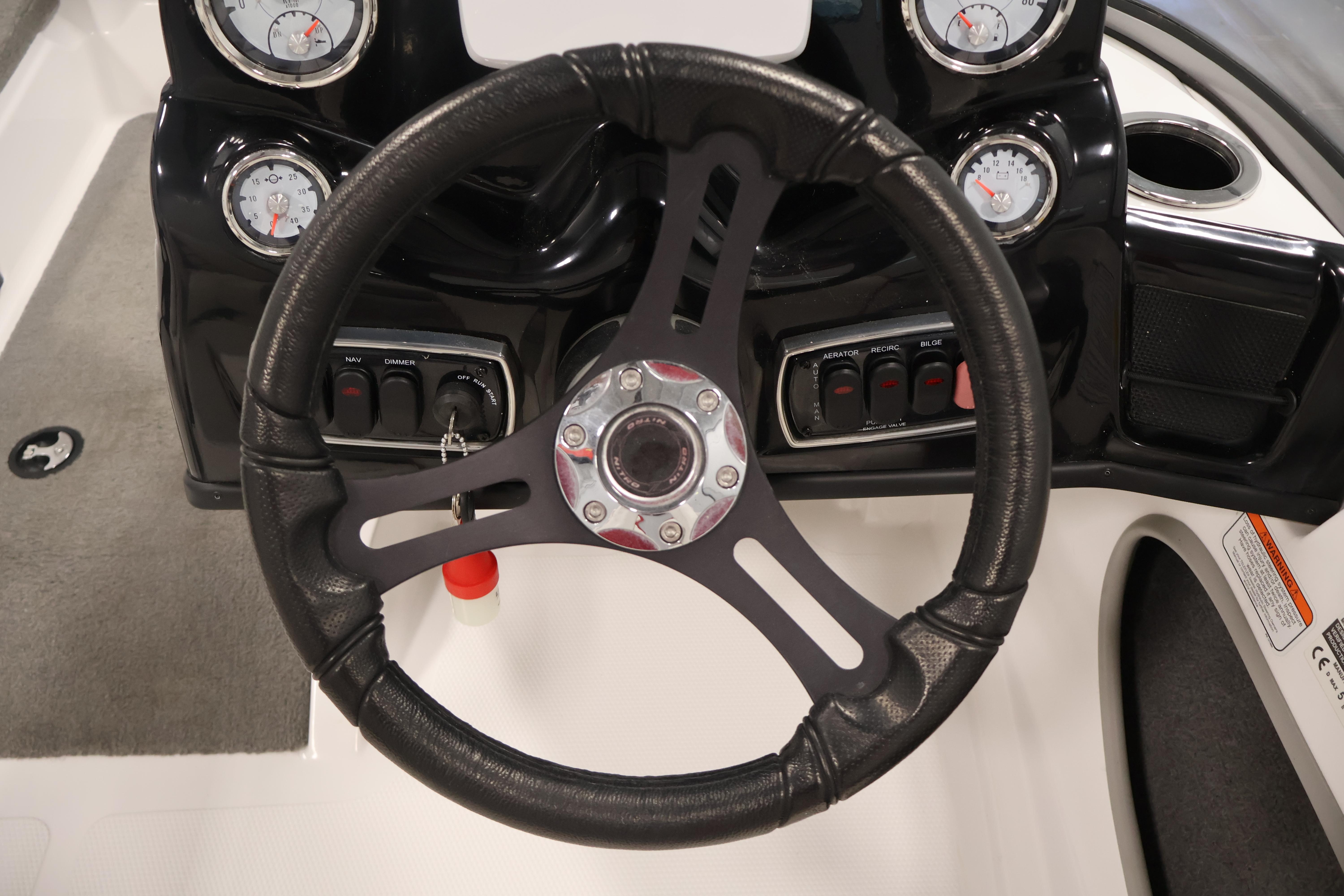 Steering wheel and dashboard of 2019 Nitro Z19 Sport boat with gauges and controls.
