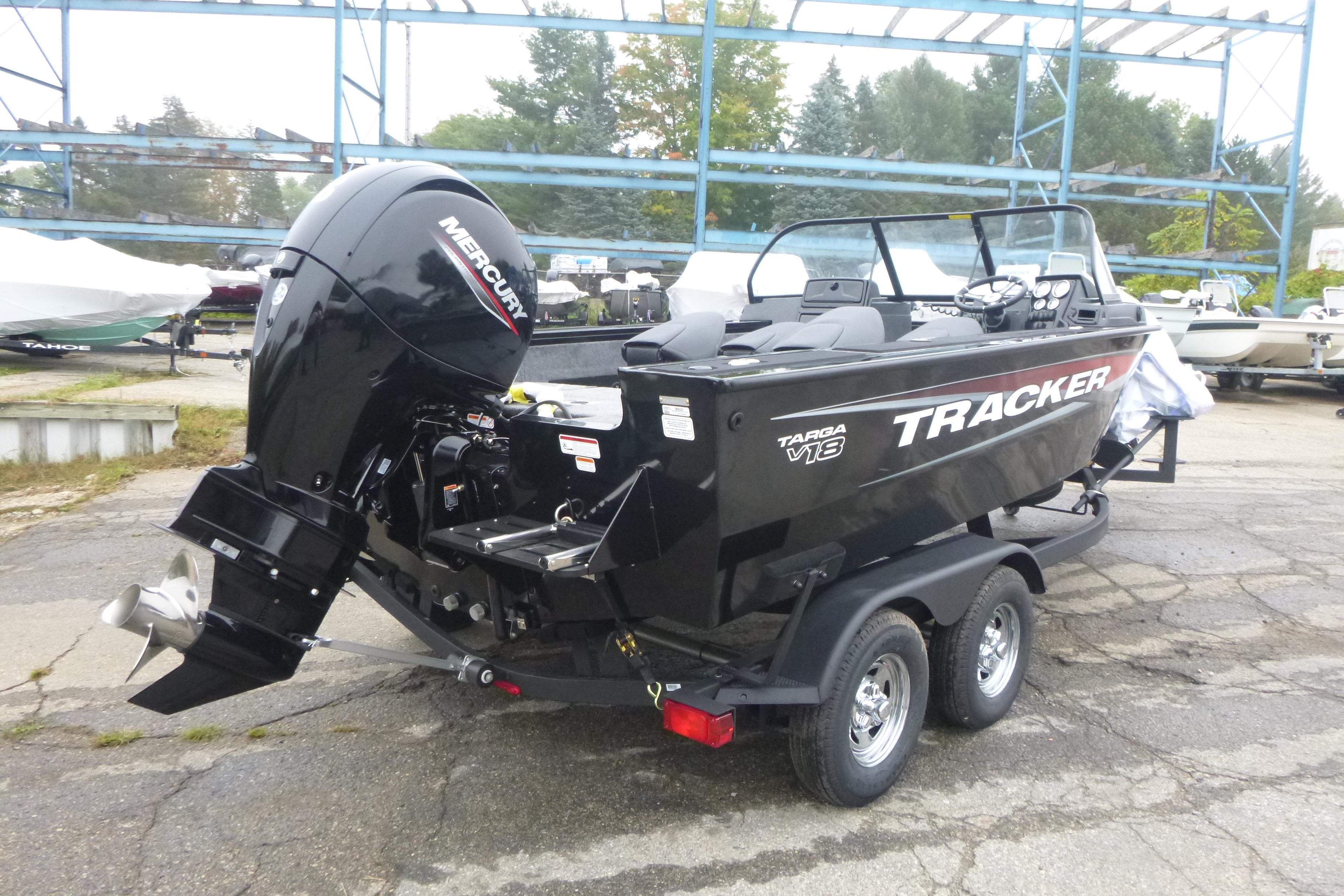 2026 Tracker Targa V-18 Combo boat with Mercury engine on trailer, parked outdoors.