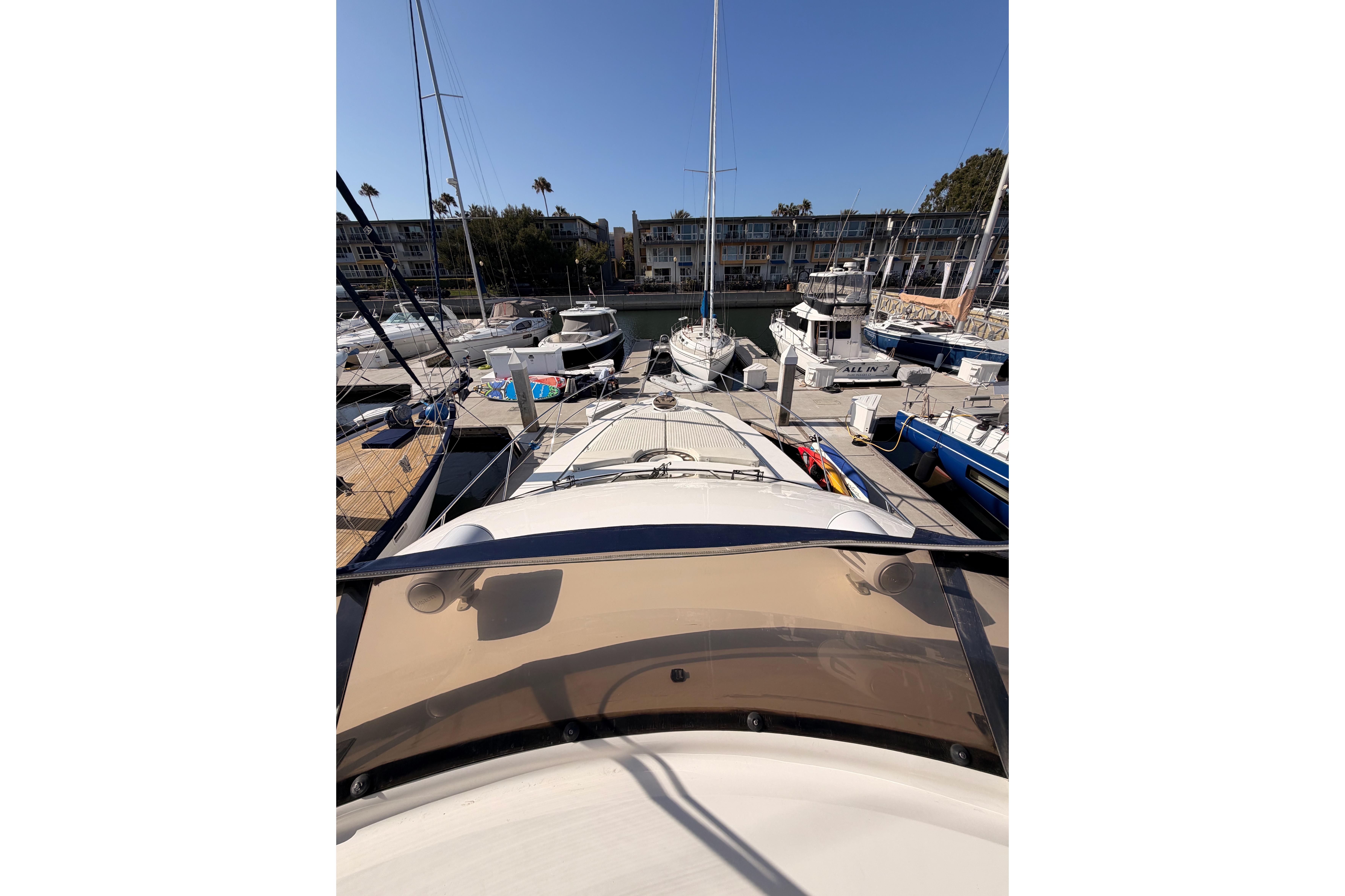 2001 Fairline 55 yacht docked at a marina, surrounded by other boats.