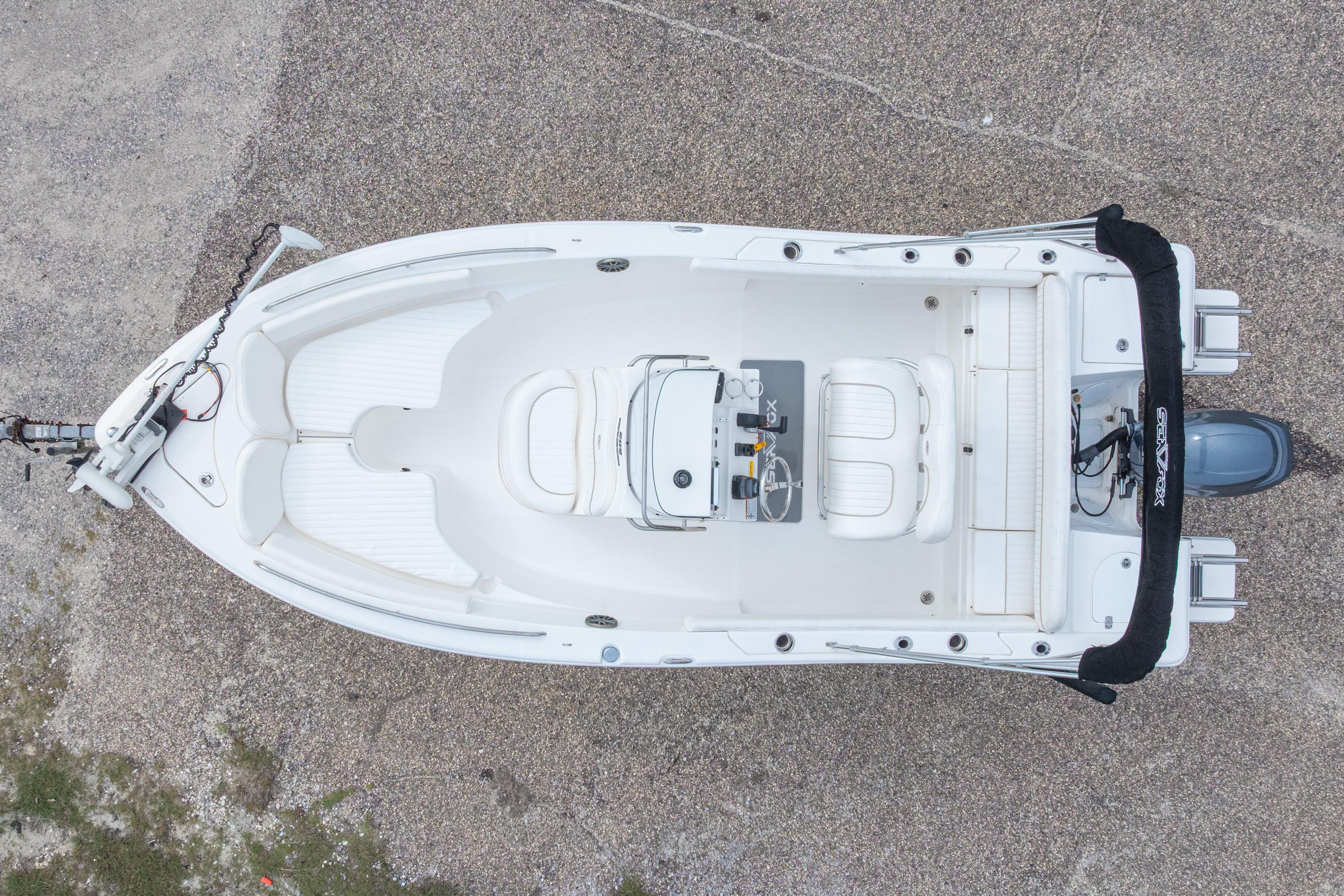 Overhead view of a 2014 Sea Fox 209 Commander boat on a gravel surface.