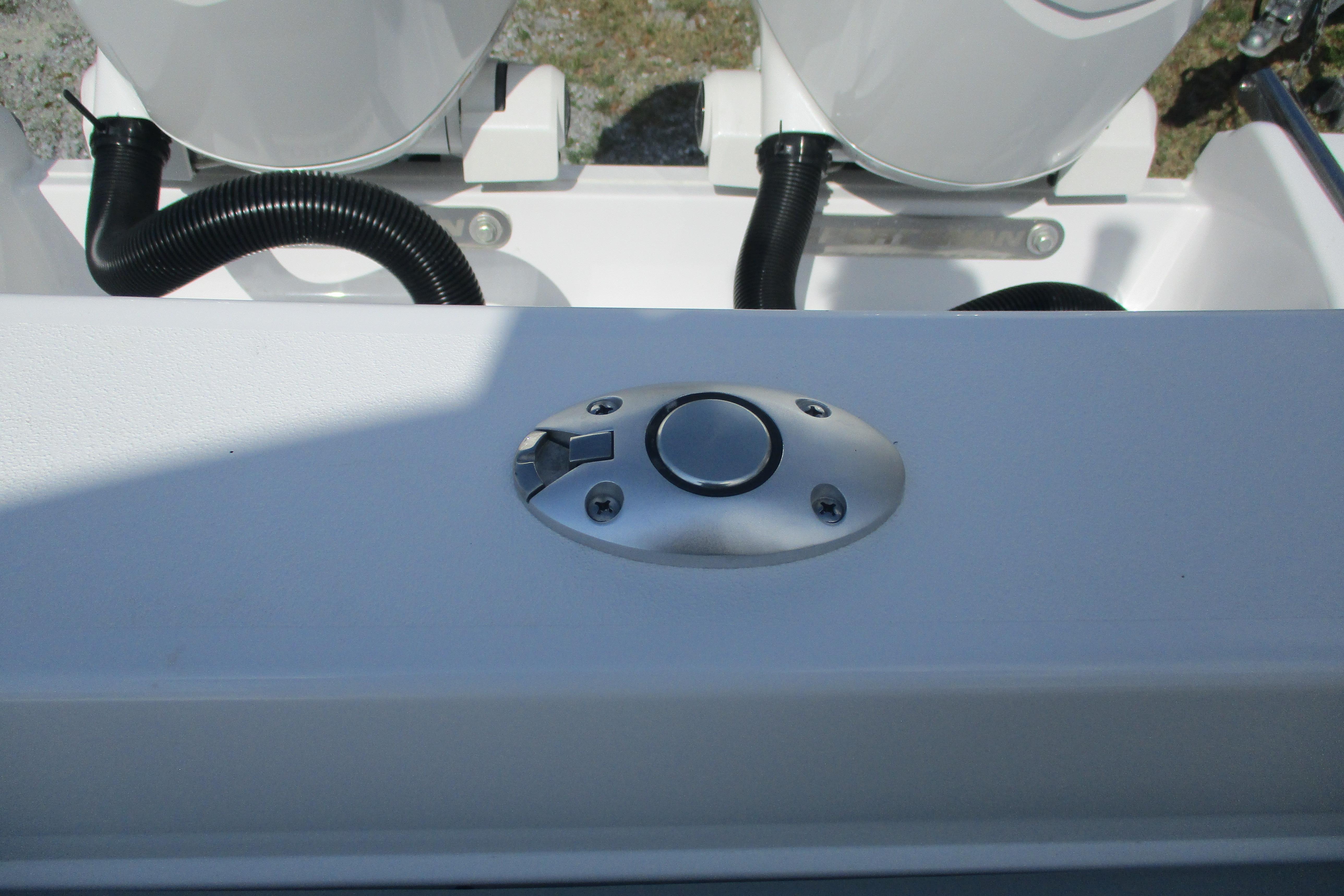 2026 Sportsman Open 252 Center Console boat detail with control button and hoses.