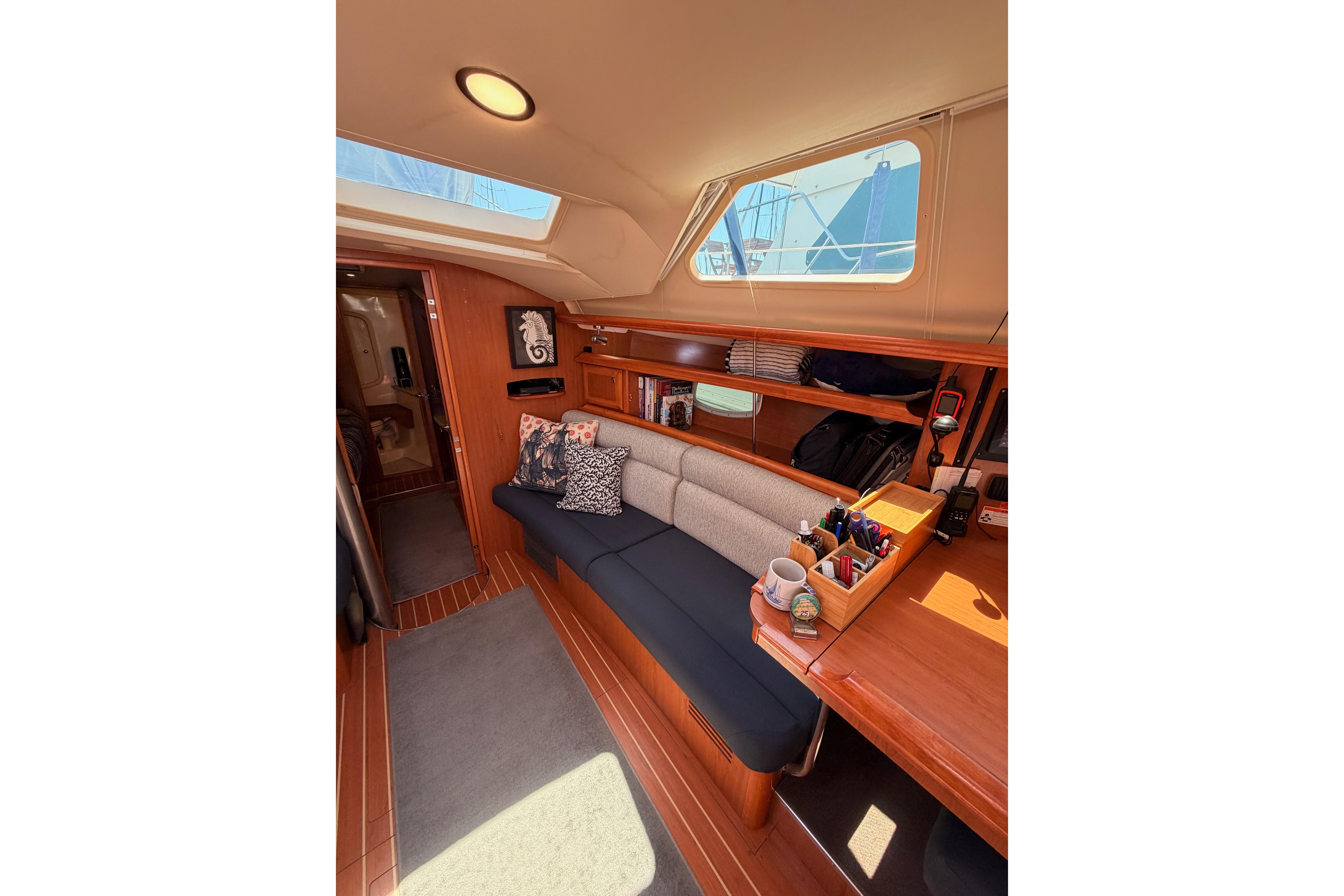 Interior of 2008 Hunter 45 Deck Salon yacht with cozy seating and wooden accents.