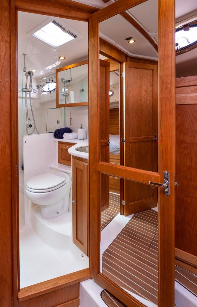 2026 Back Cove 372 yacht bathroom with wooden cabinetry and modern fixtures.