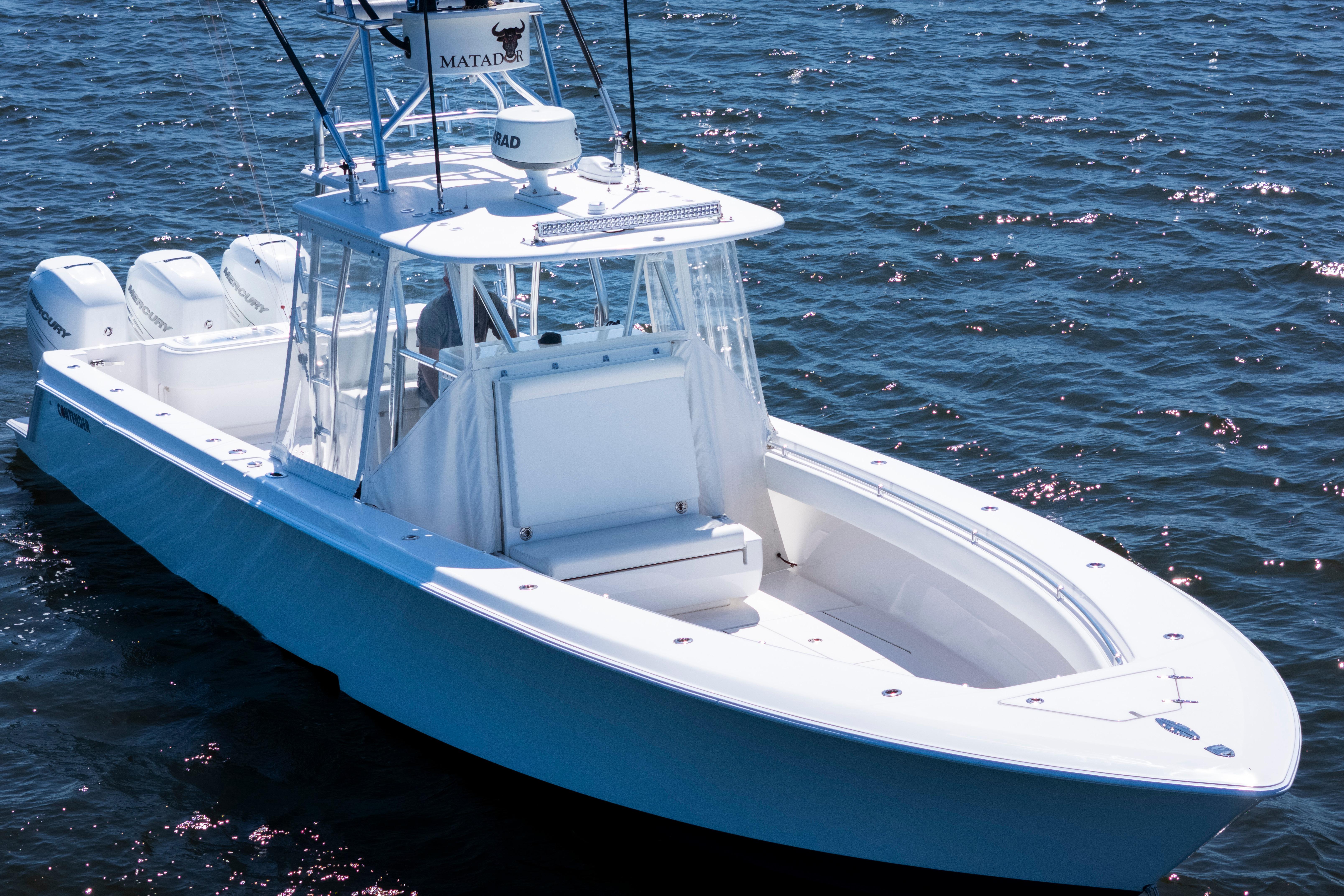 2015 Contender 39 ST boat on water, featuring sleek design and triple outboard engines.