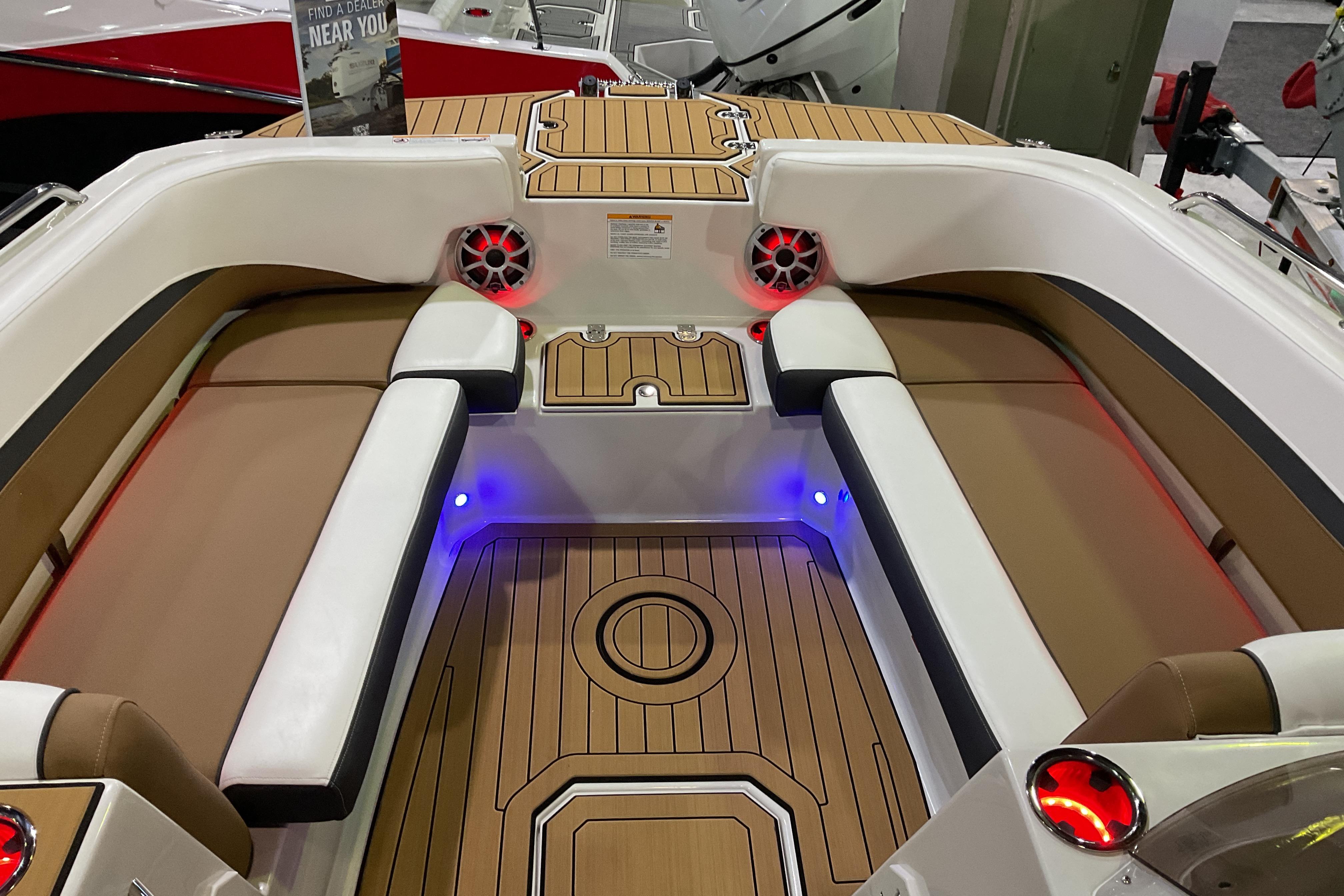 2026 Starcraft SVX 211 OB boat interior with cushioned seating and ambient lighting.