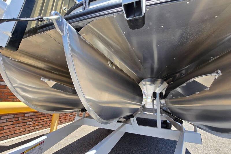 Underneath view of 2026 Berkshire STS Arch Performance Series pontoon boat on trailer.