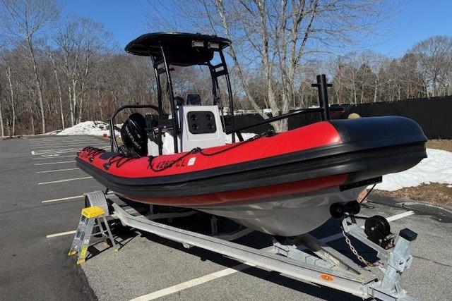 2024 Inmar 660-DR boat on trailer in parking lot, red and black design.