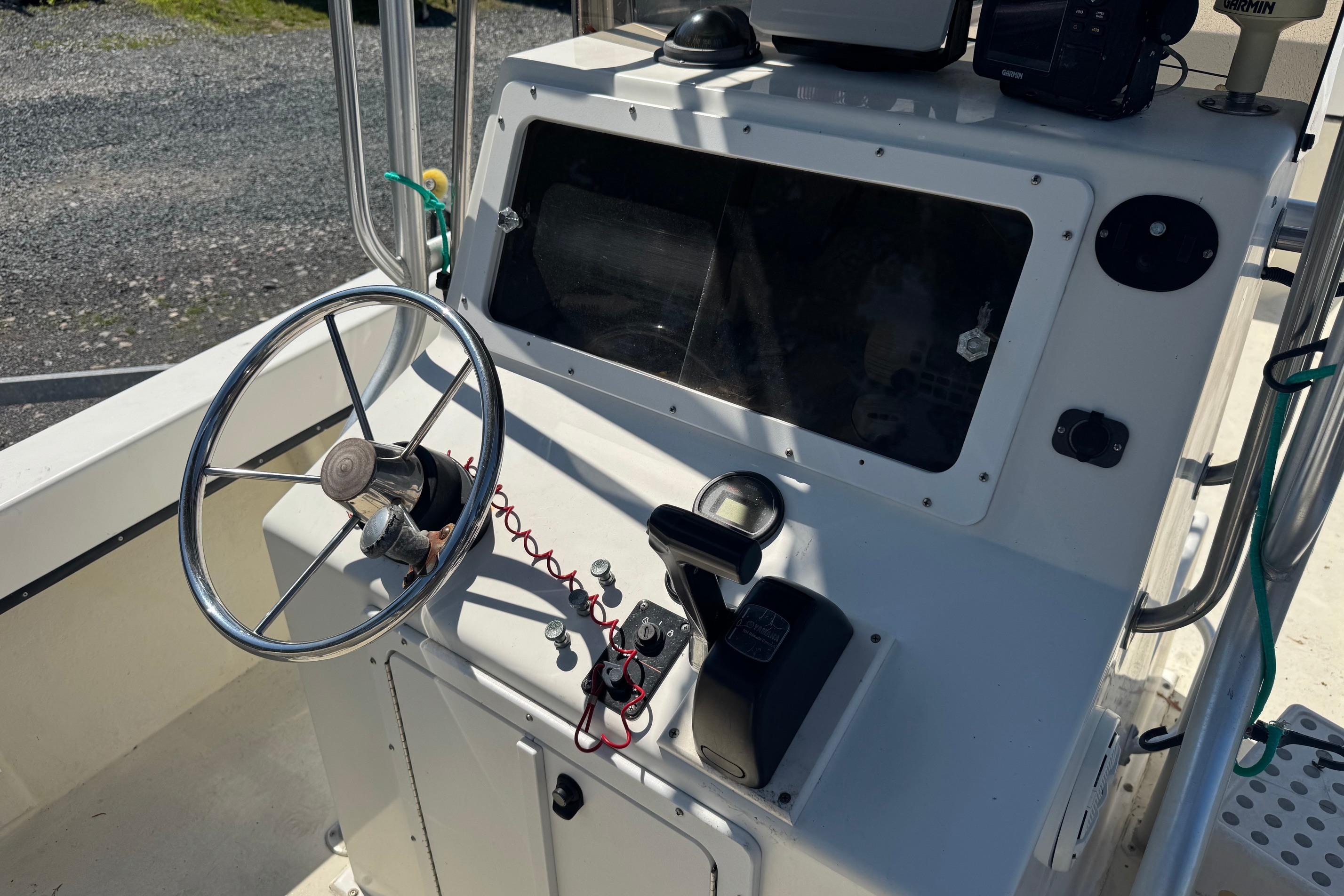 1997 Maycraft 23 boat console with steering wheel and navigation equipment.