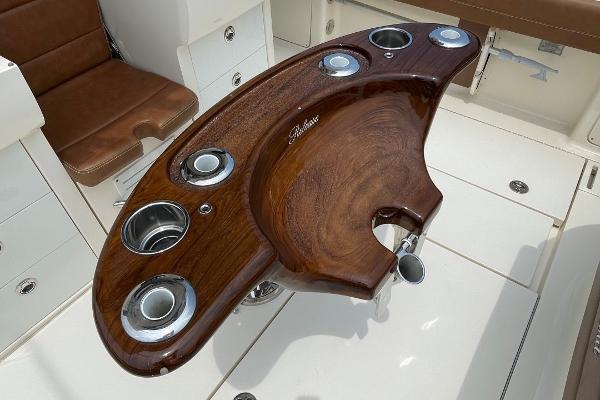 Luxurious wooden helm station on 2020 Scout 420 LXF boat with cup holders.