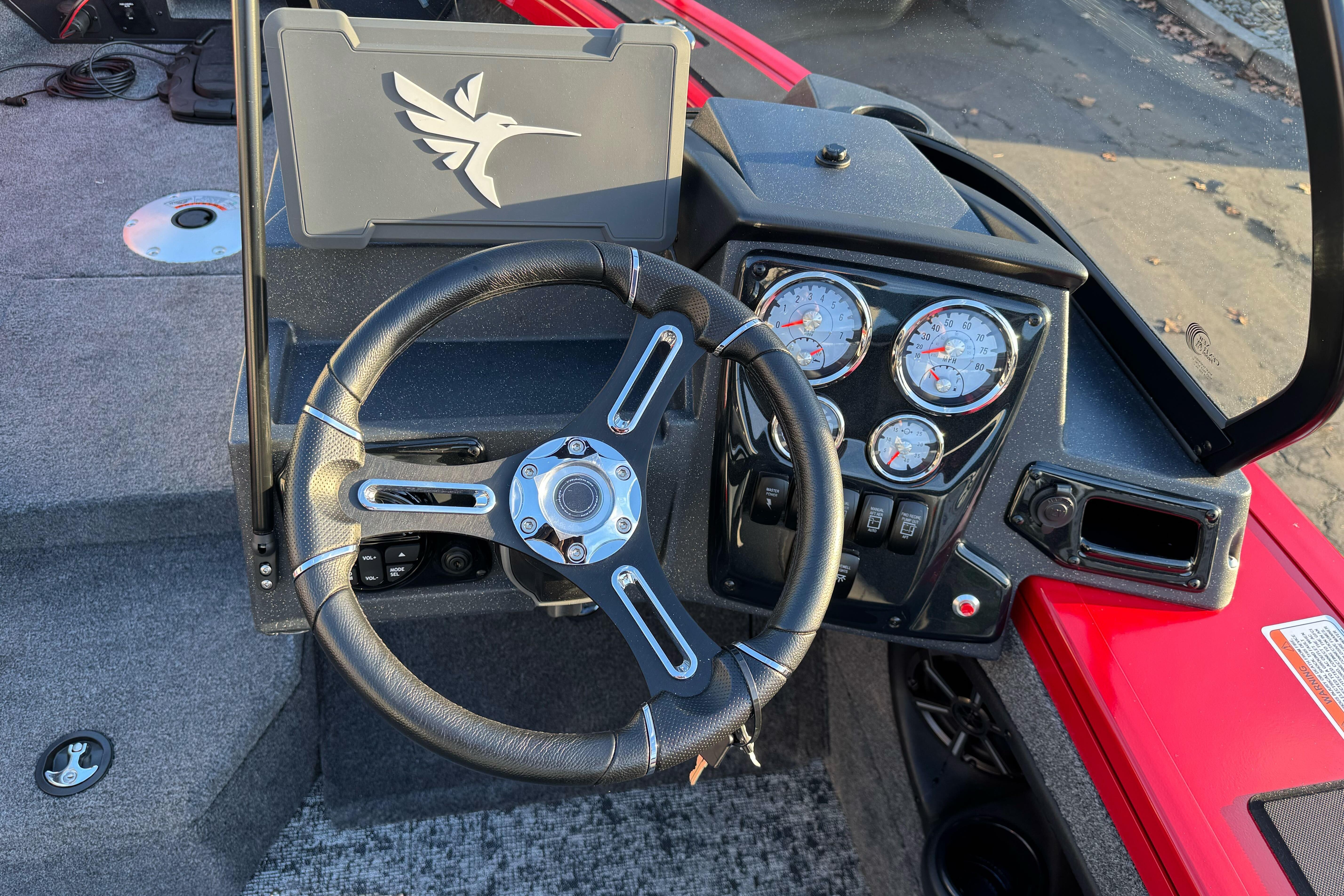 Steering console of 2026 Tracker Targa V-18 WT boat with gauges and controls.