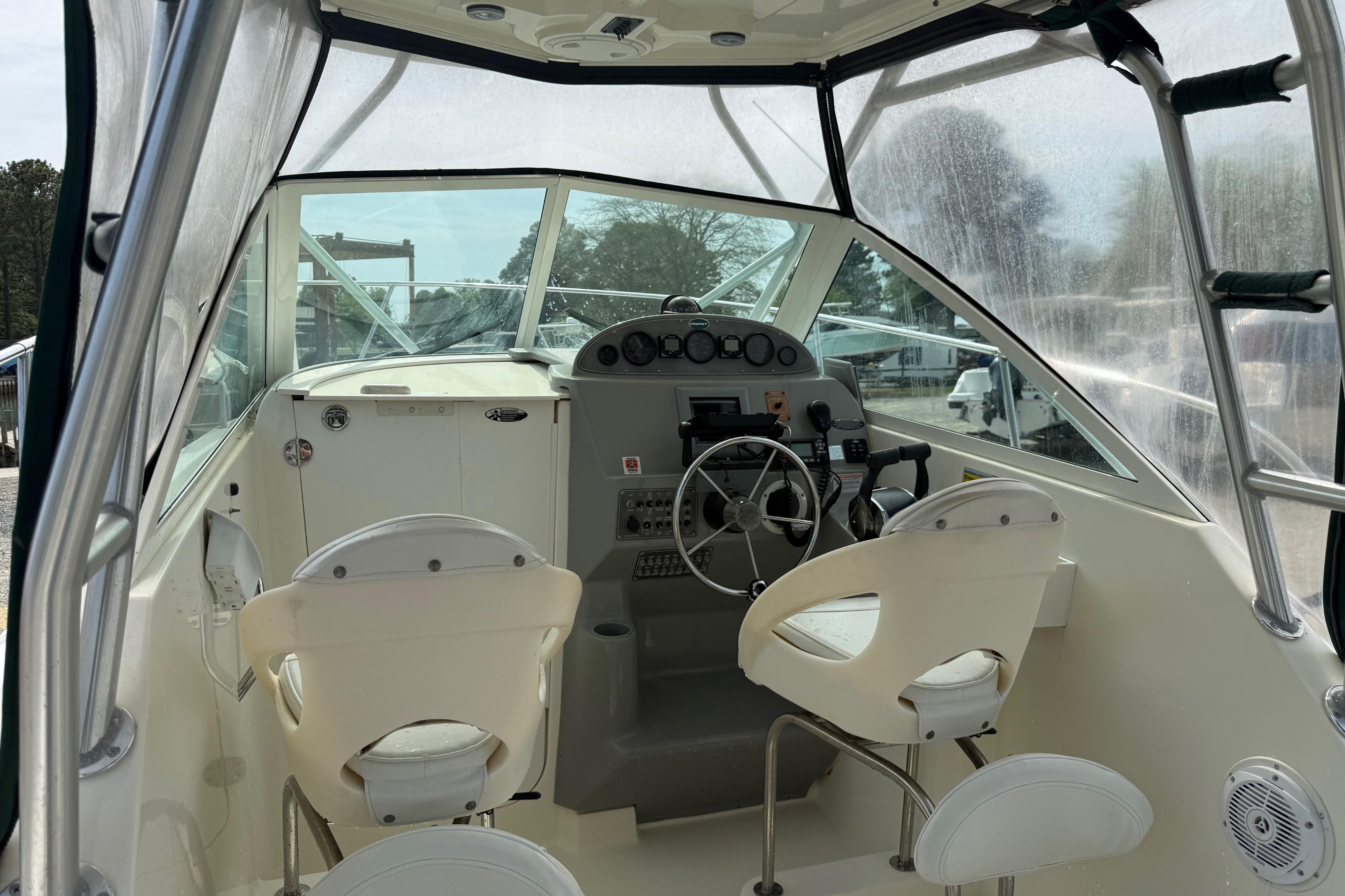 2006 Trophy 2502 Walkaround boat interior with steering wheel and seating.