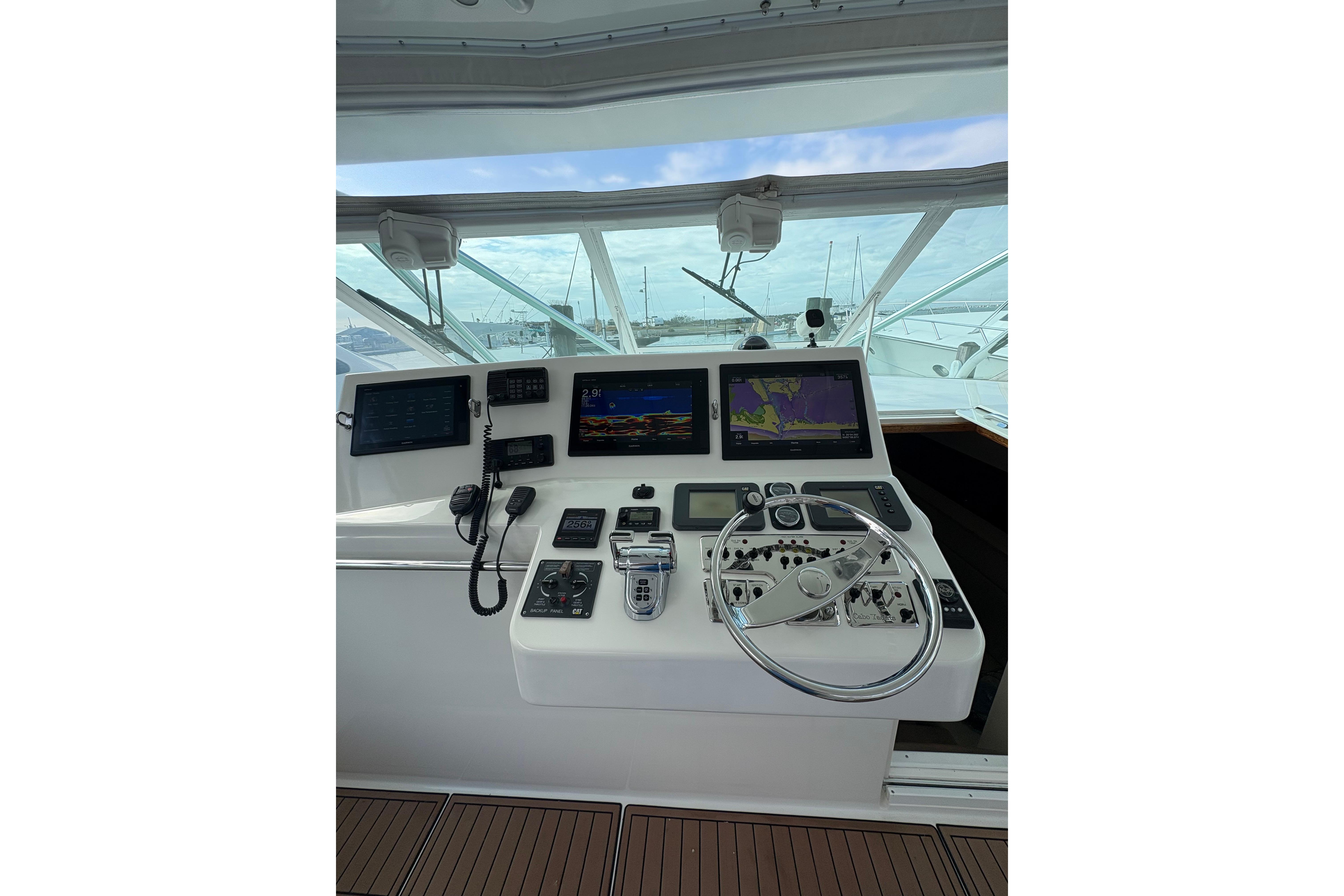 Helm of 2004 Cabo 40 Hardtop Express with navigation screens and controls.