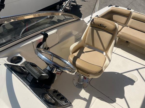 2019 Scout 210 Dorado boat interior with steering wheel and captain's chair.