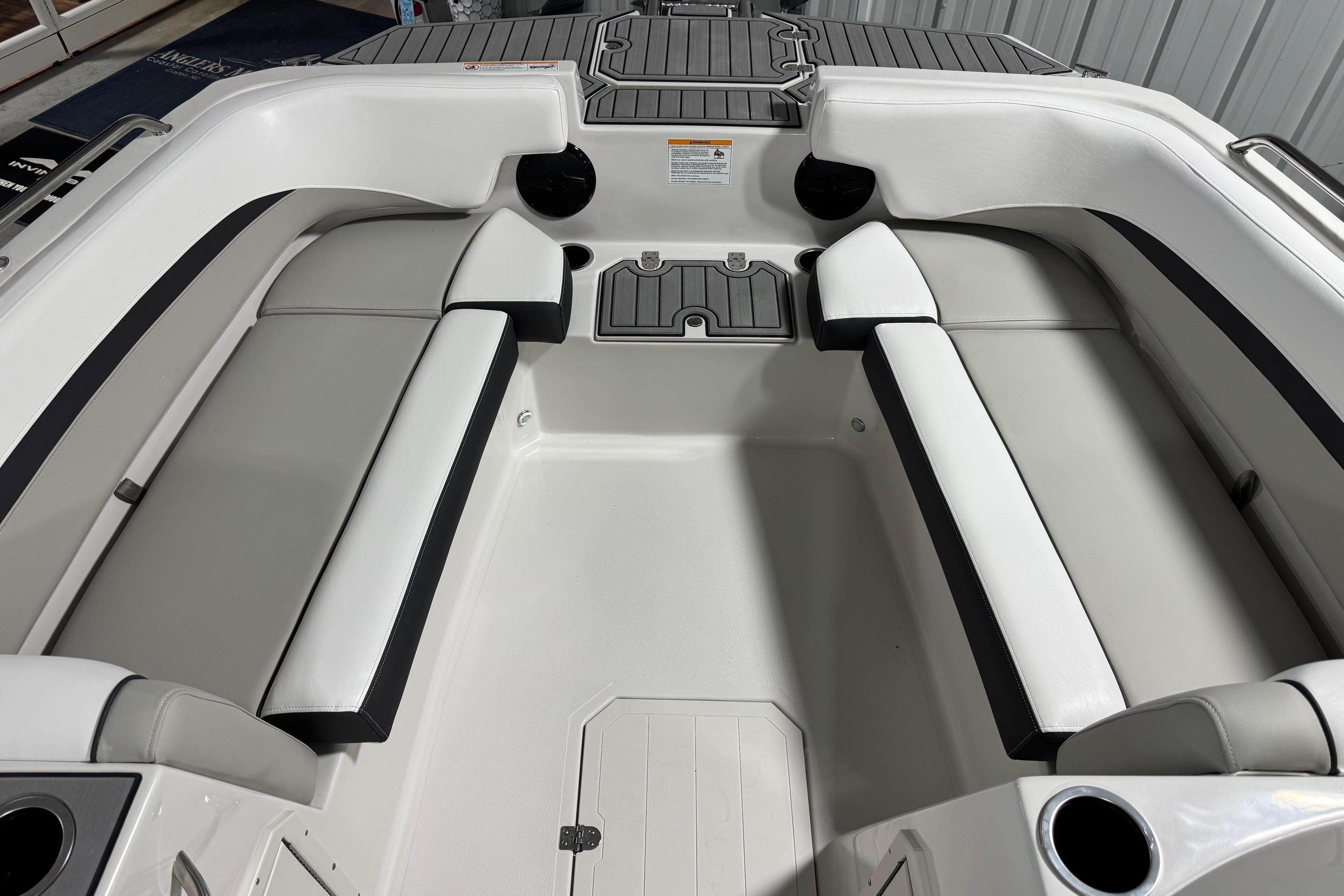 2026 Starcraft SVX 191 OB boat interior with white and gray seating, cup holders, and storage compartments.