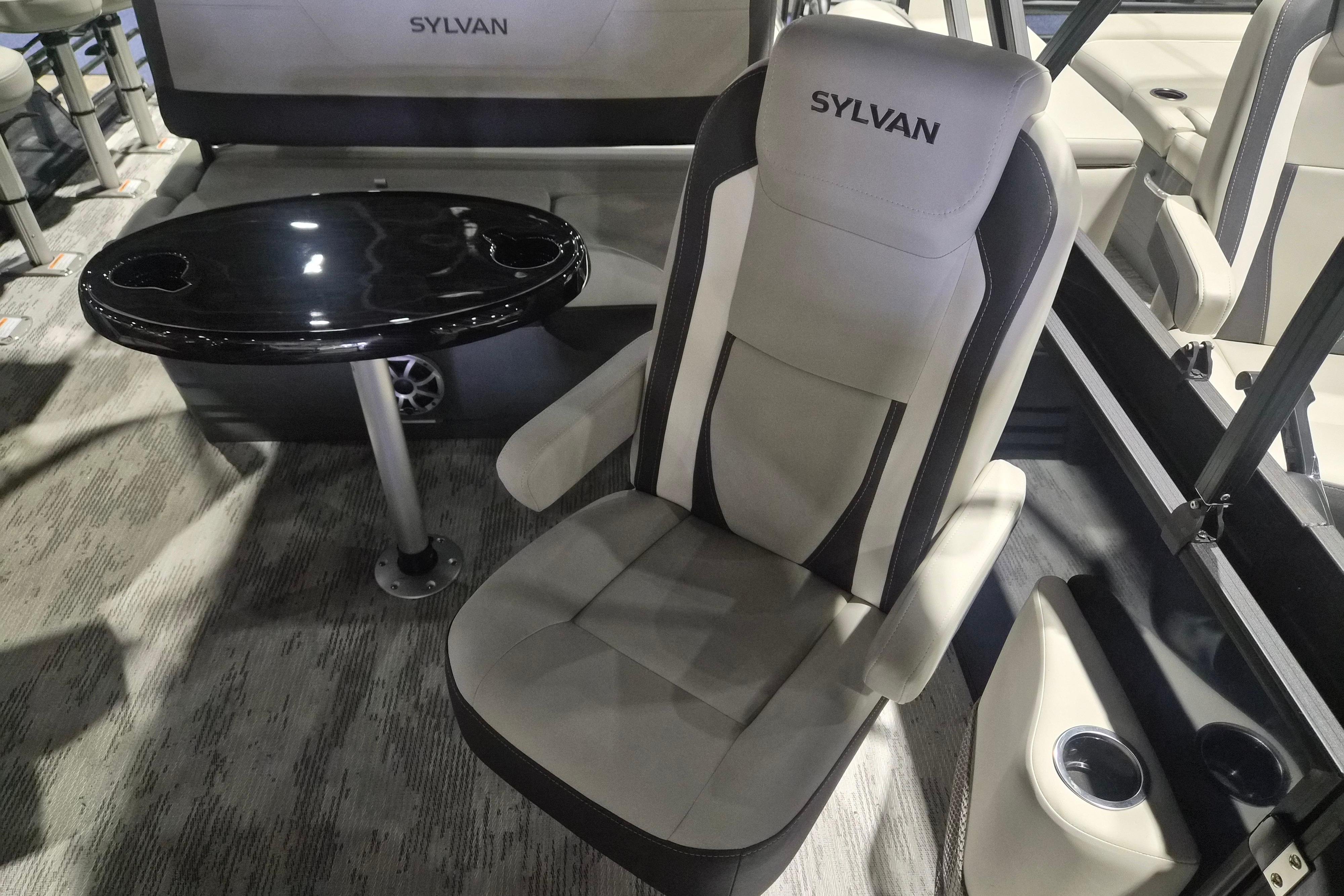 Luxurious seating and table in 2026 Sylvan R-22 LZ DH boat interior.