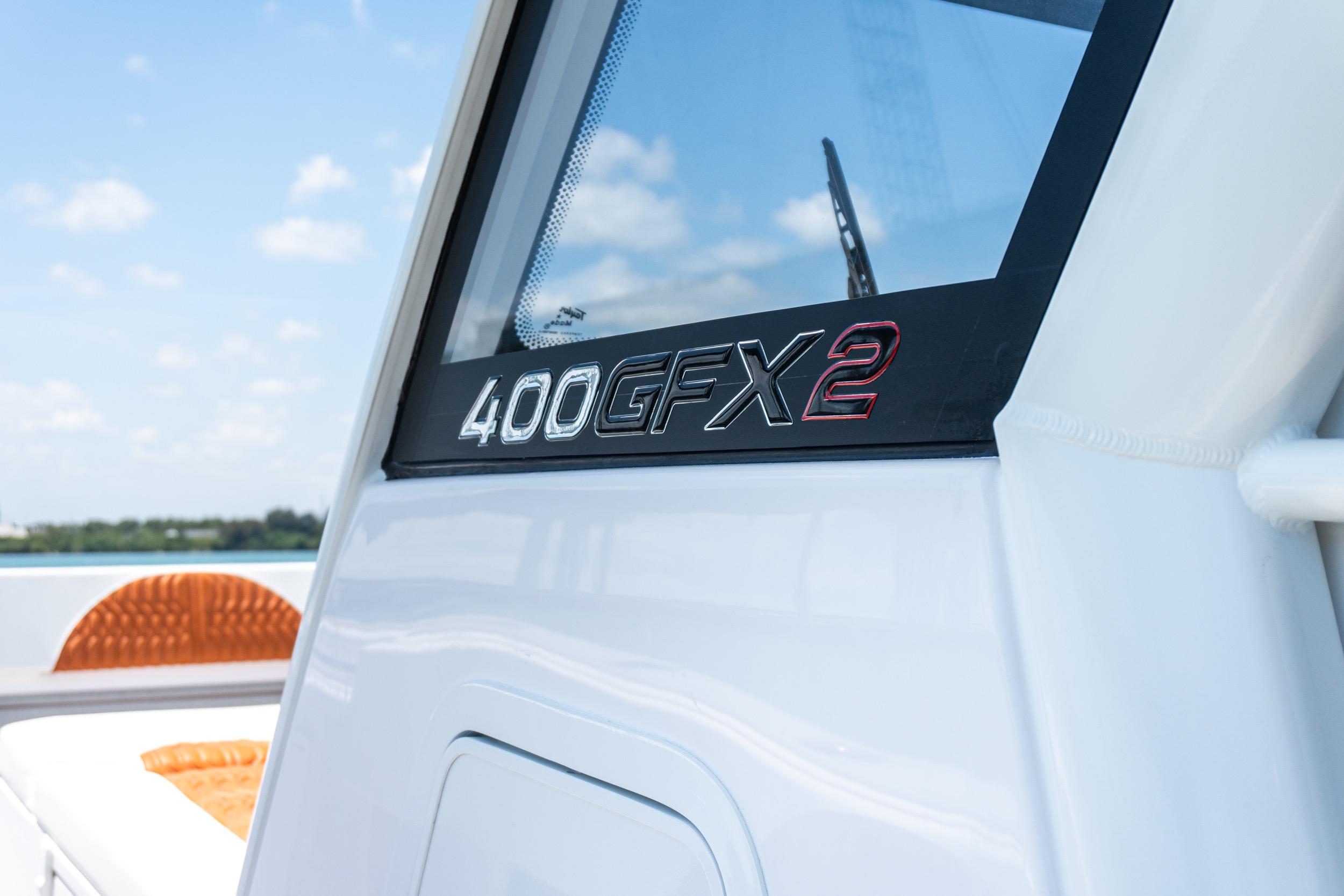 Close-up of 2026 Twin Vee 400 GFX2 CC boat model name on white exterior.