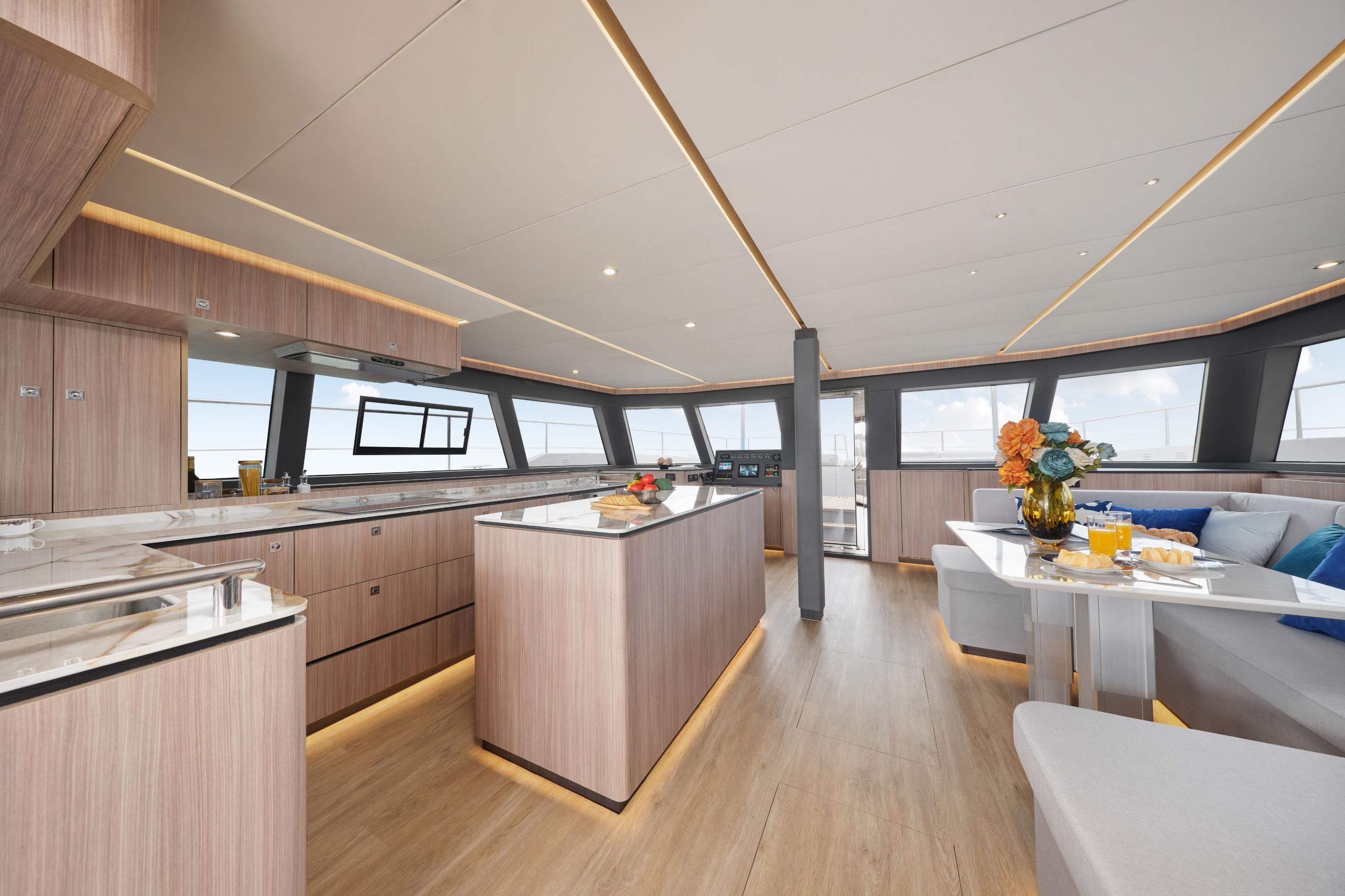 Luxurious interior of 2026 Heysea SV60 yacht with modern kitchen and dining area.