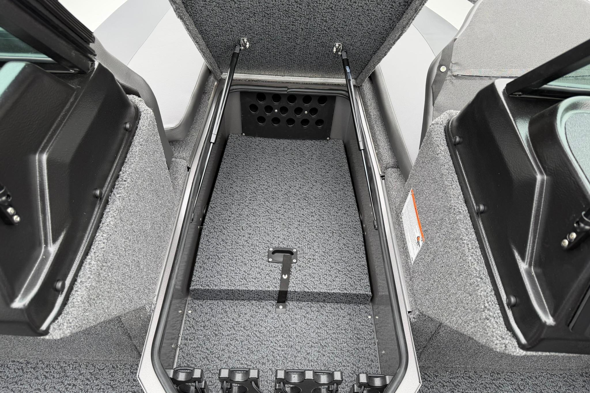 2027 Lund 2075 Impact XS boat storage compartment with open lid, showcasing interior design.