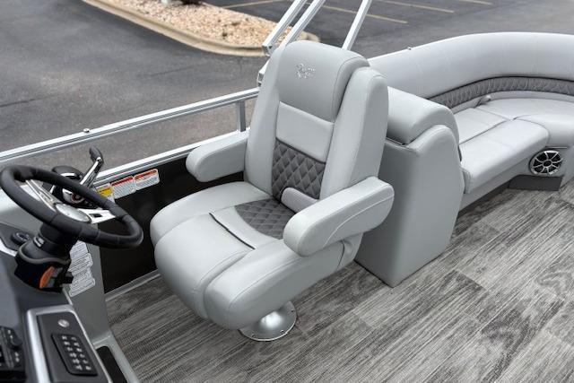 2025 Ranger Reata 243C boat interior with luxurious seating and modern steering console.