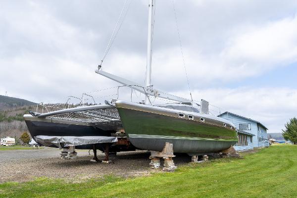 Shuttleworth 52 AeroRig catamaran, 2025 model, on land with a scenic backdrop.