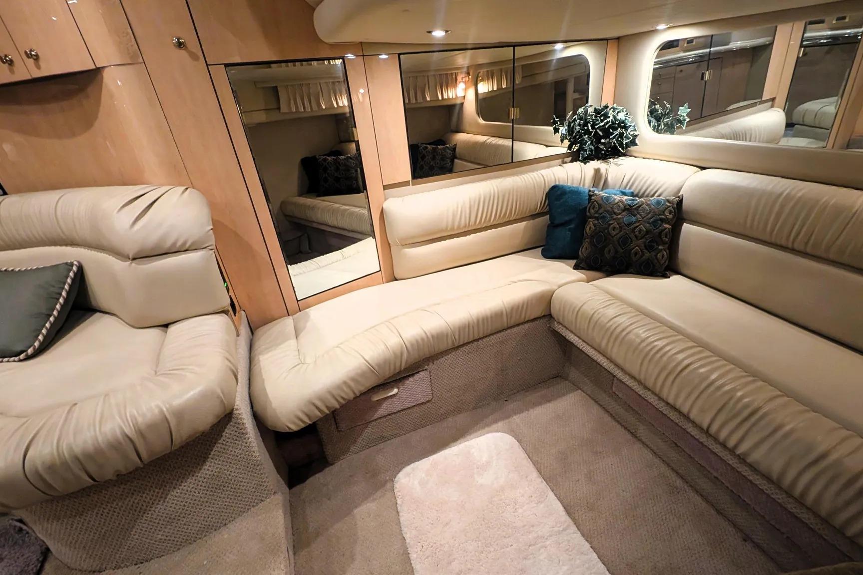 Luxurious interior of 2000 Sea Ray 380 Sundancer yacht with plush seating and elegant decor.