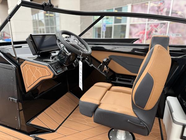 2025 Yamaha Boats 255XD interior with modern dashboard and tan seating.