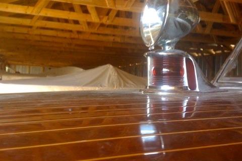 1931 Hacker-Craft 26 Dolphin with polished wood finish in a wooden boathouse.