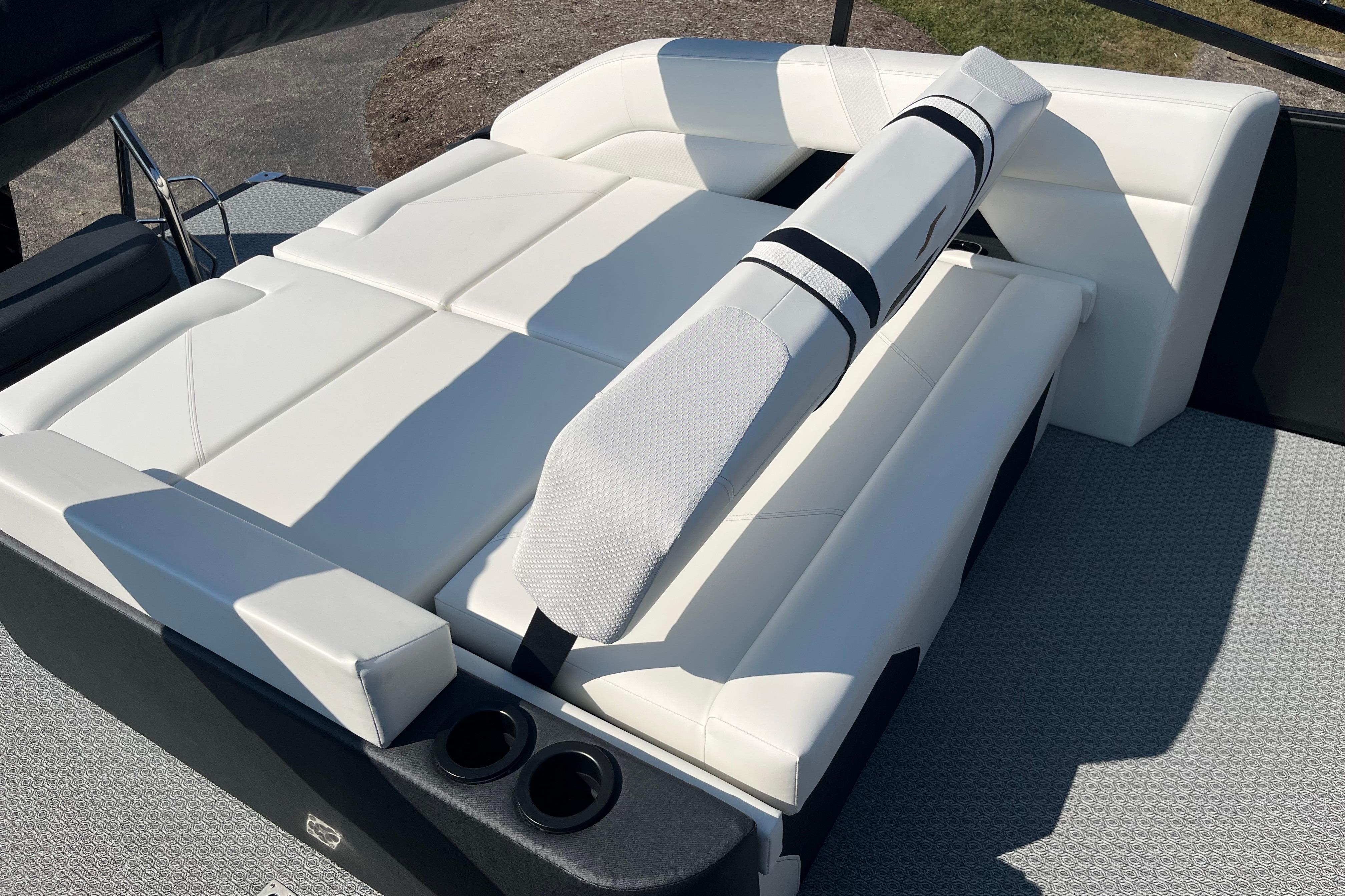 Luxurious white seating on 2026 Evotti 725CS boat, featuring adjustable backrest and cup holders.