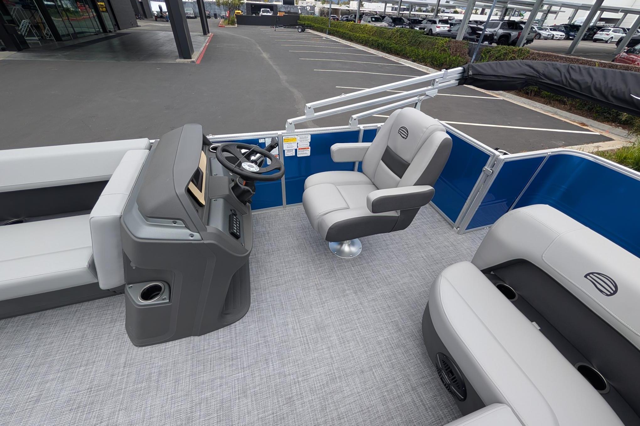 2026 Sun Tracker Party Barge 18 DLX interior with steering console and seating.