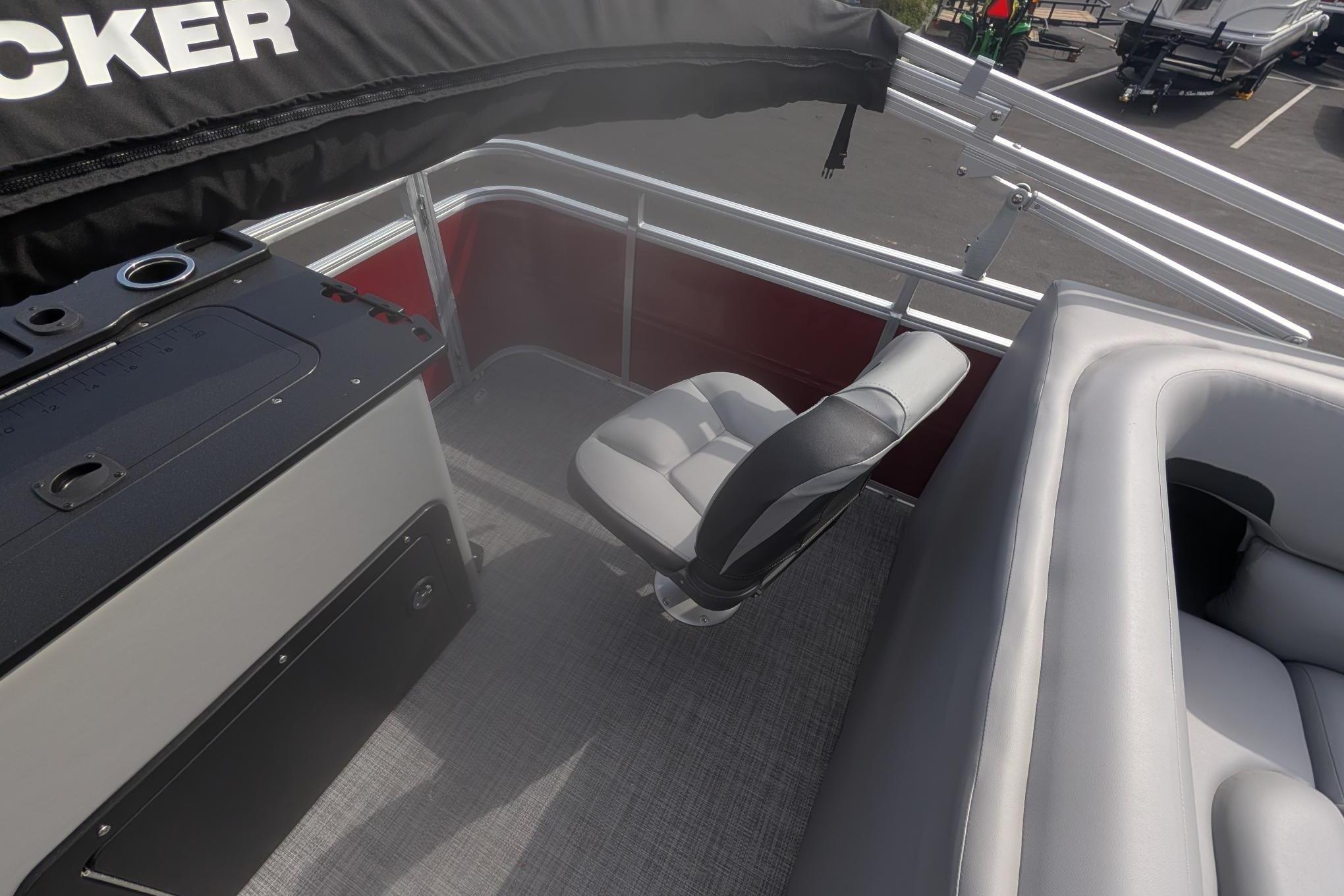 2026 Sun Tracker SportFish 20 DLX interior with seating and console, showcasing modern design.