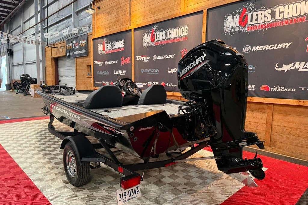 2024 Tracker Pro Team 175 boat with Mercury engine displayed indoors.