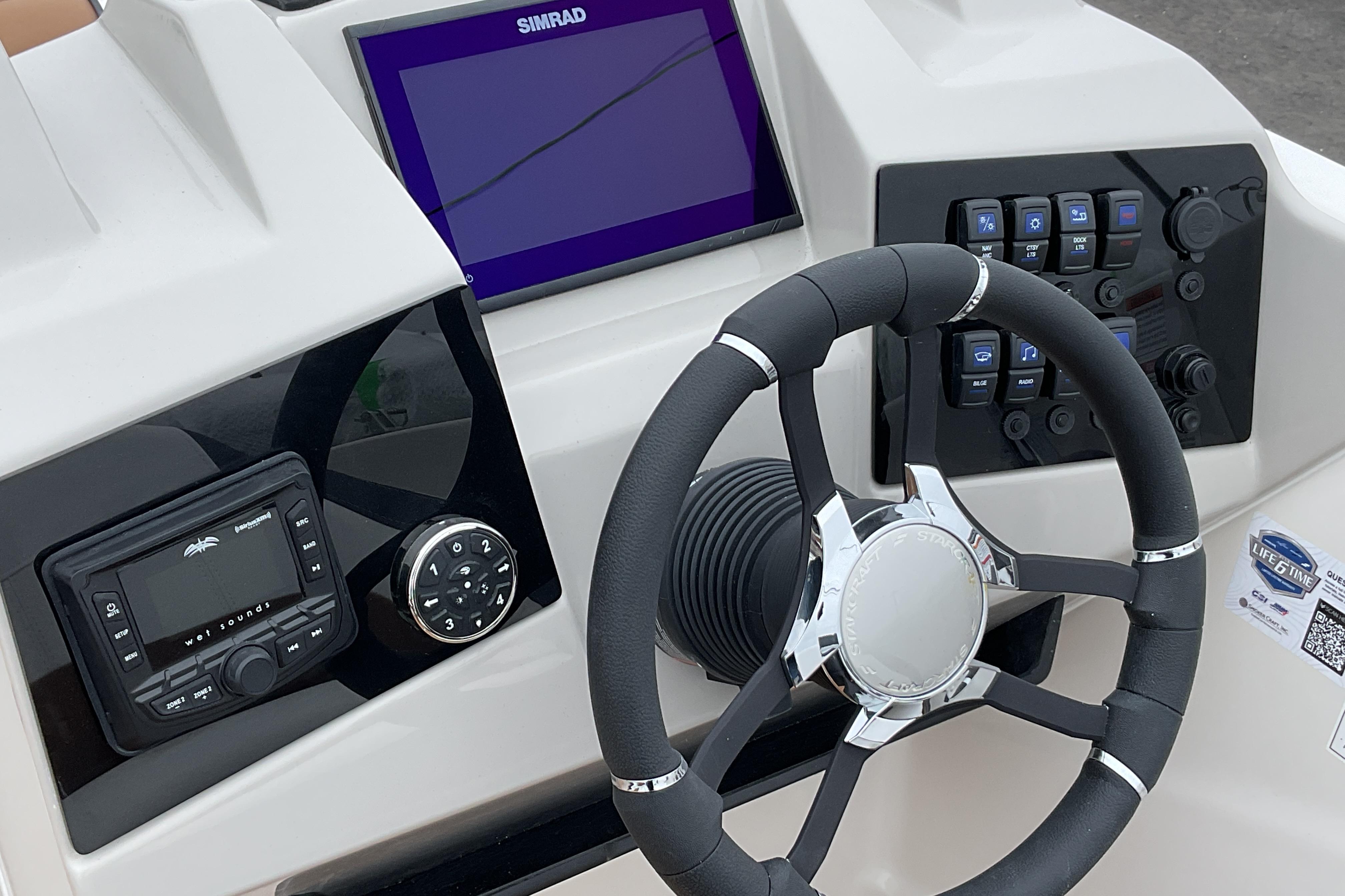 2026 Starcraft SVX 211 OB boat dashboard with steering wheel and control panel.